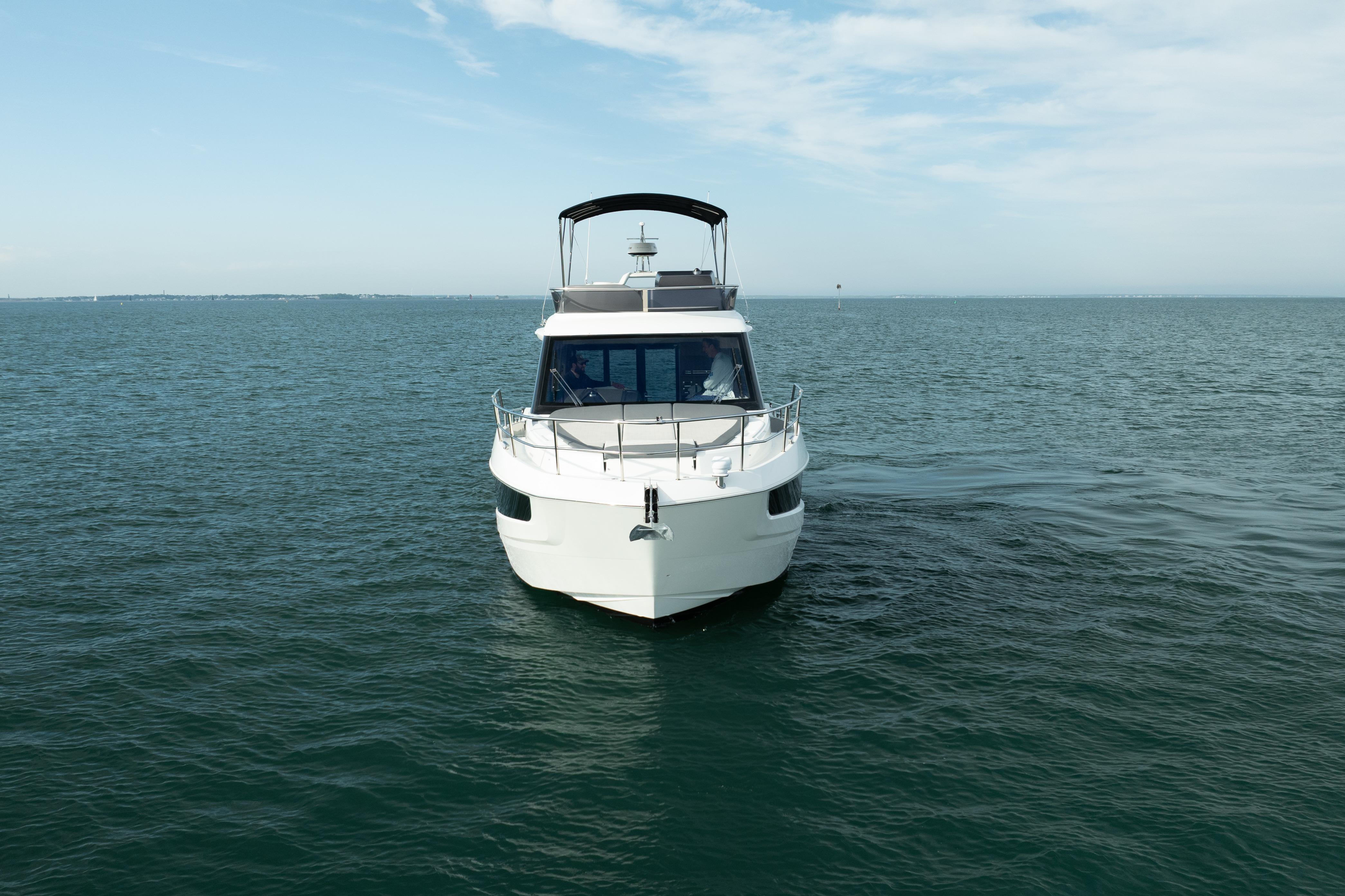 2023 Galeon 400 Fly yacht cruising on open water under a clear sky.