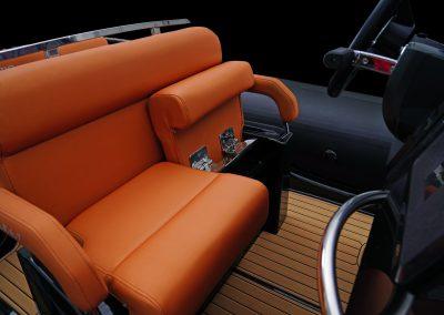 2025 Brig Eagle 6.7 PVC boat with orange seating and sleek steering wheel.