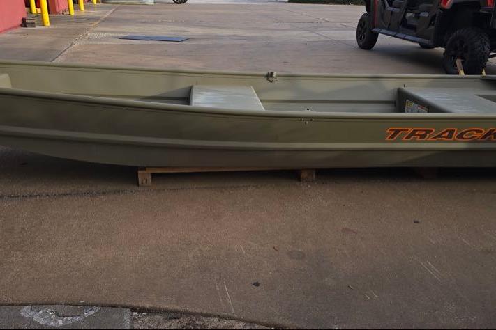 2026 Tracker Grizzly 14 Jon boat on display in outdoor setting.