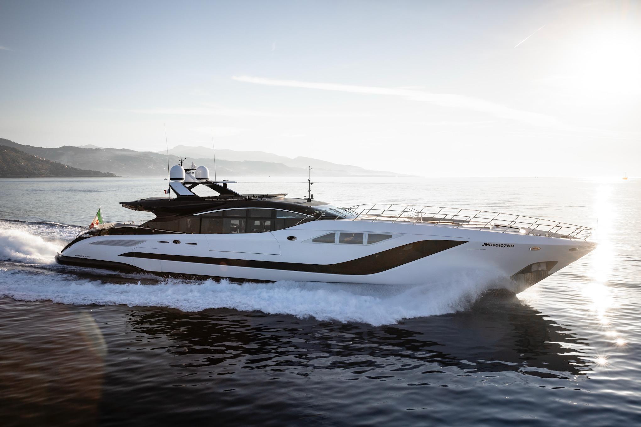 Luxury 2023 Overmarine Mangusta 165 Rev yacht cruising at sunset.
