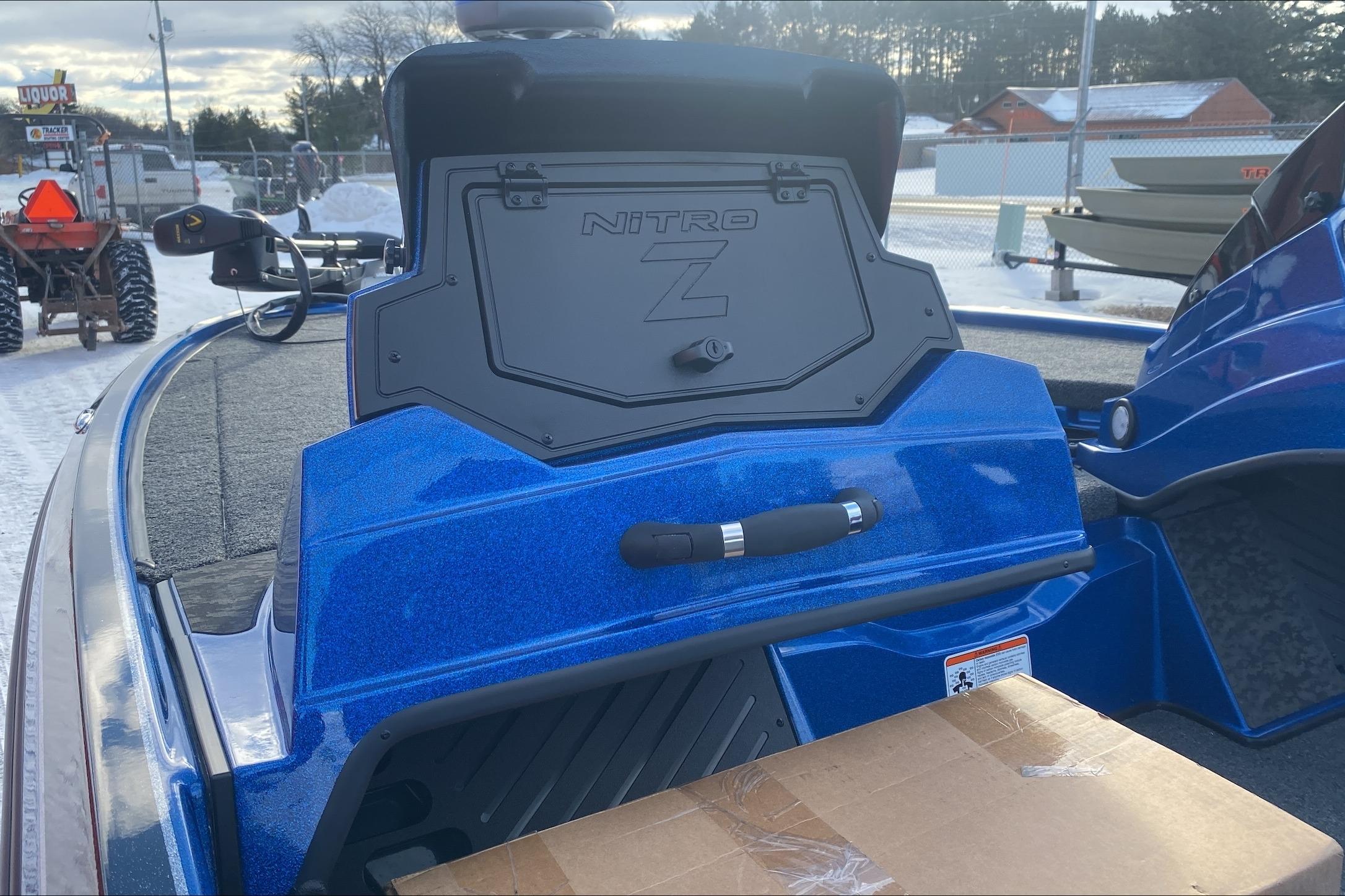 2026 Nitro Z19 XL boat in vibrant blue, parked outdoors with snow and trees in the background.