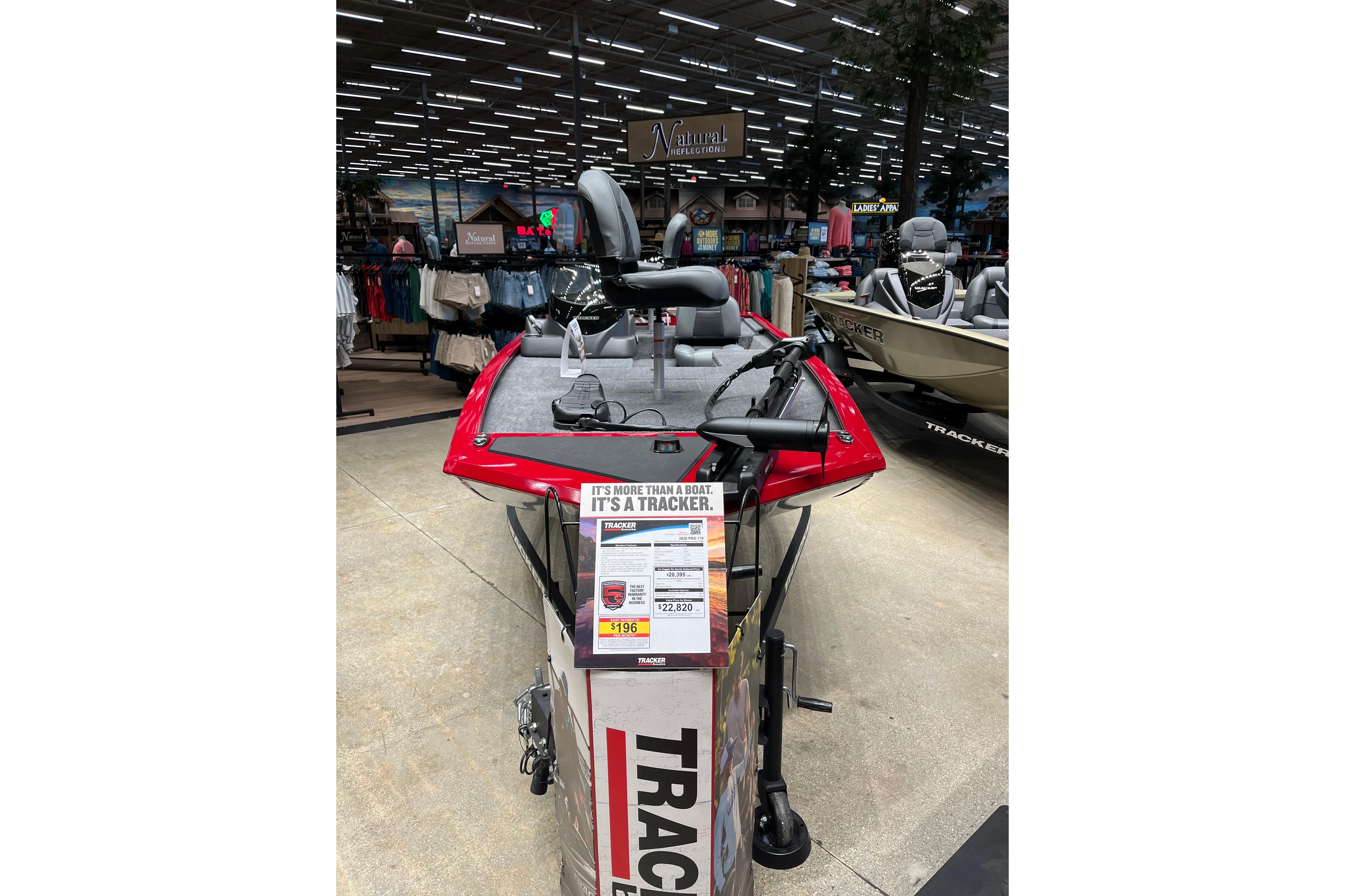 2026 Tracker Pro 170 boat displayed in a showroom with promotional signage.