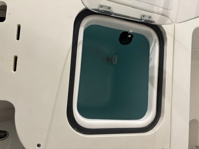 Open storage compartment in Pursuit C 238 Center Console 2022 boat.