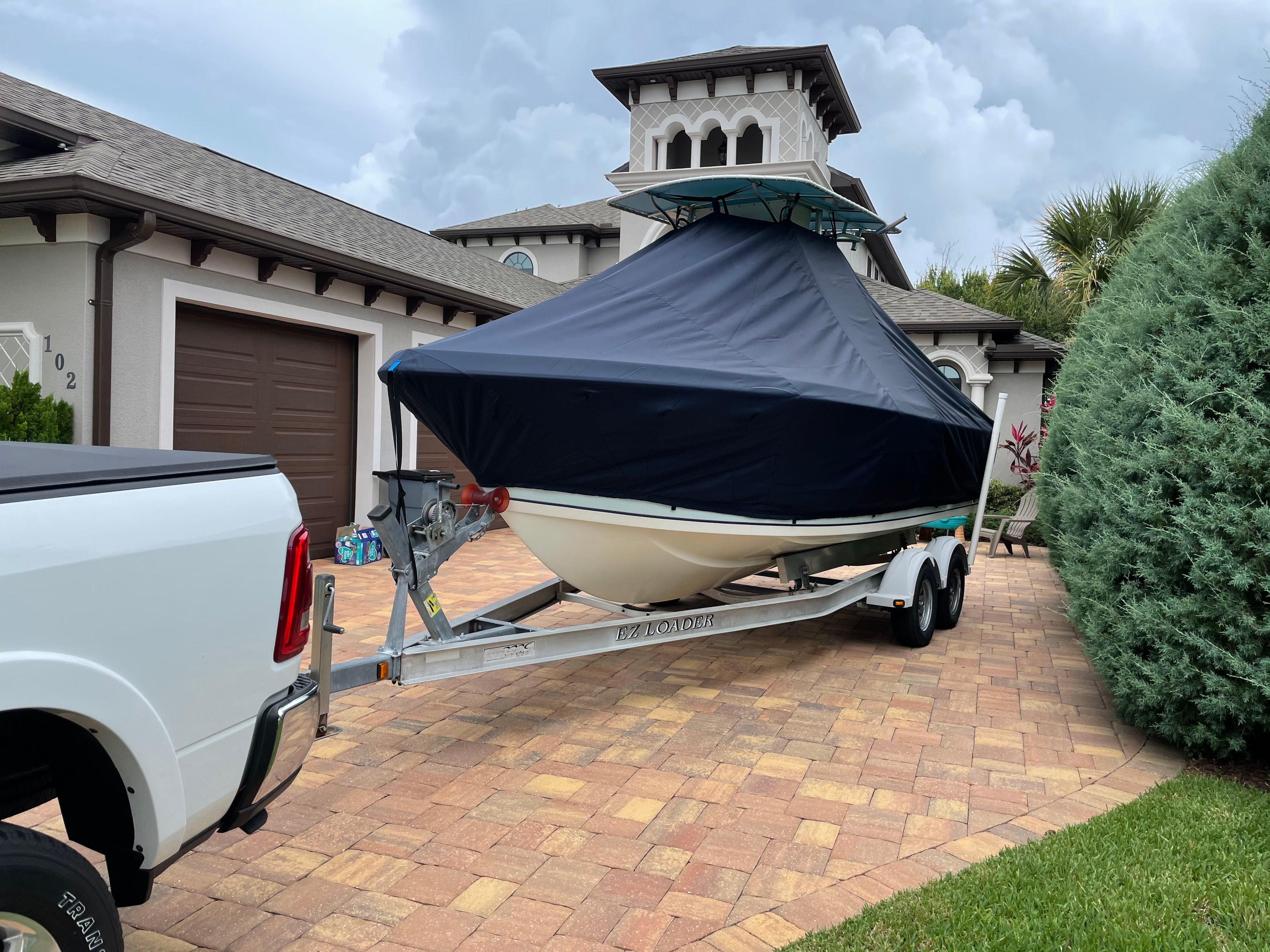2006 Sailfish 218 CC boat on trailer in front of house.