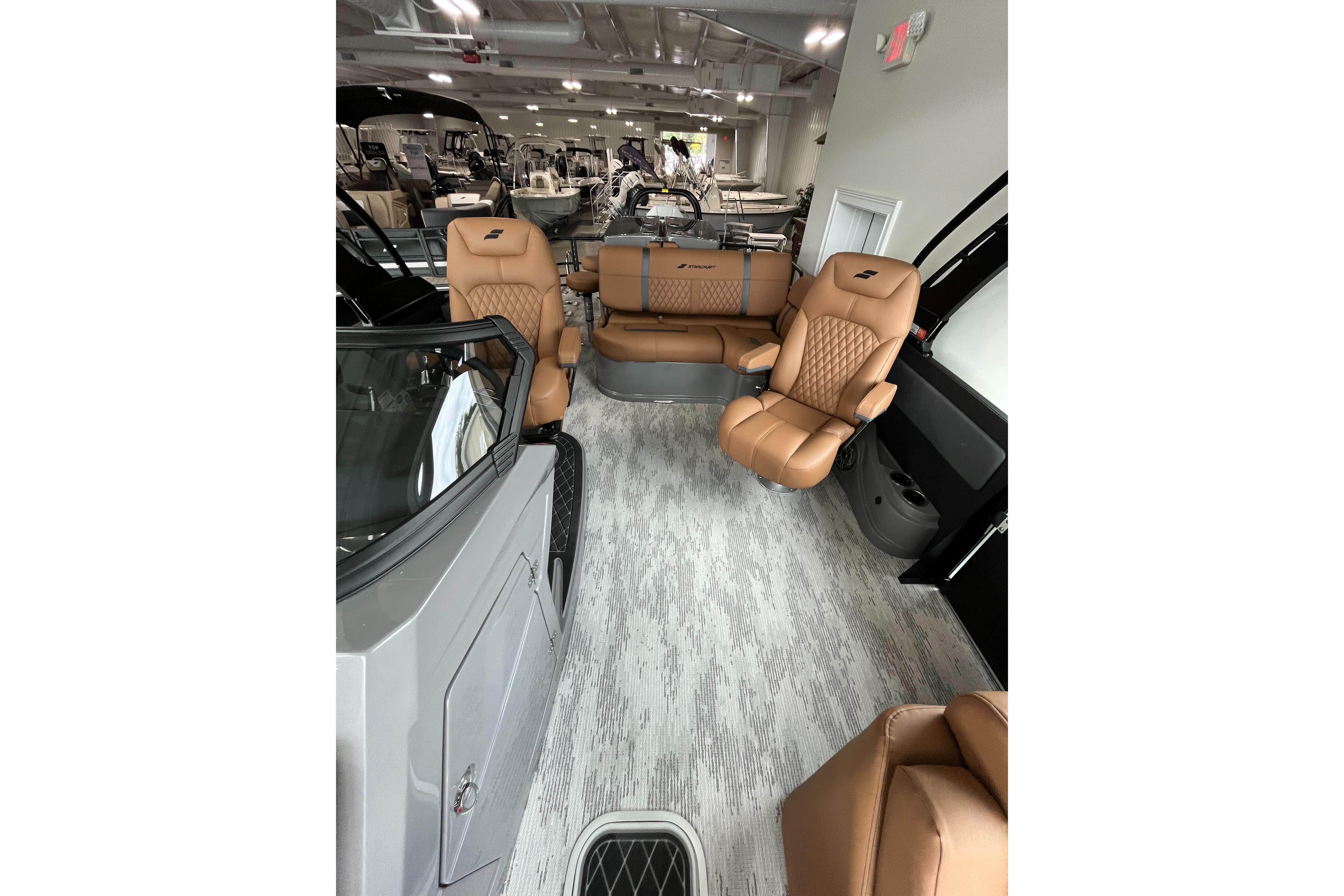 Luxurious interior of 2026 Starcraft RX 25 DL DC boat with tan leather seating.