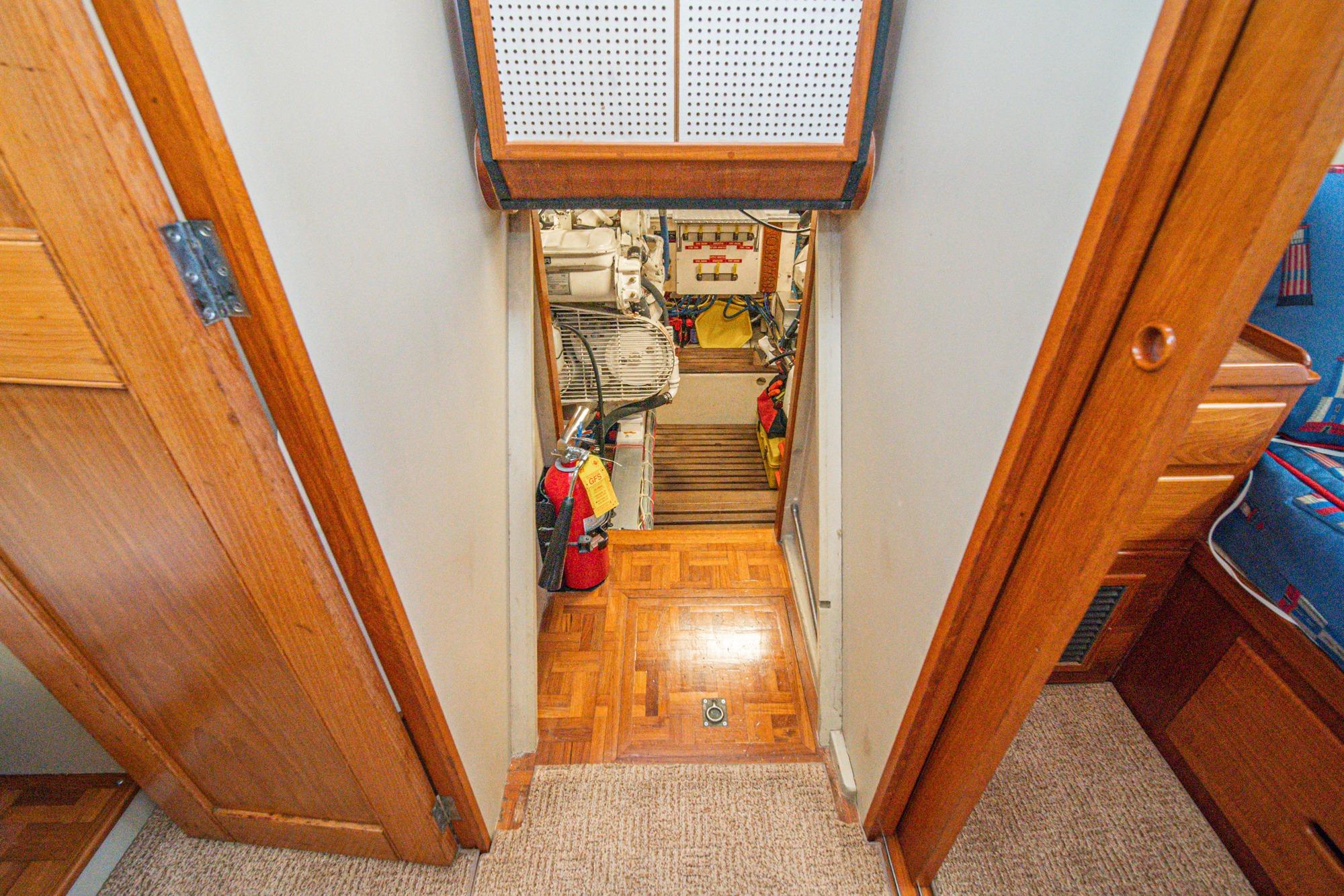 Engine room entrance of 1987 Grand Banks 46 Classic yacht, featuring wooden interior and equipment.