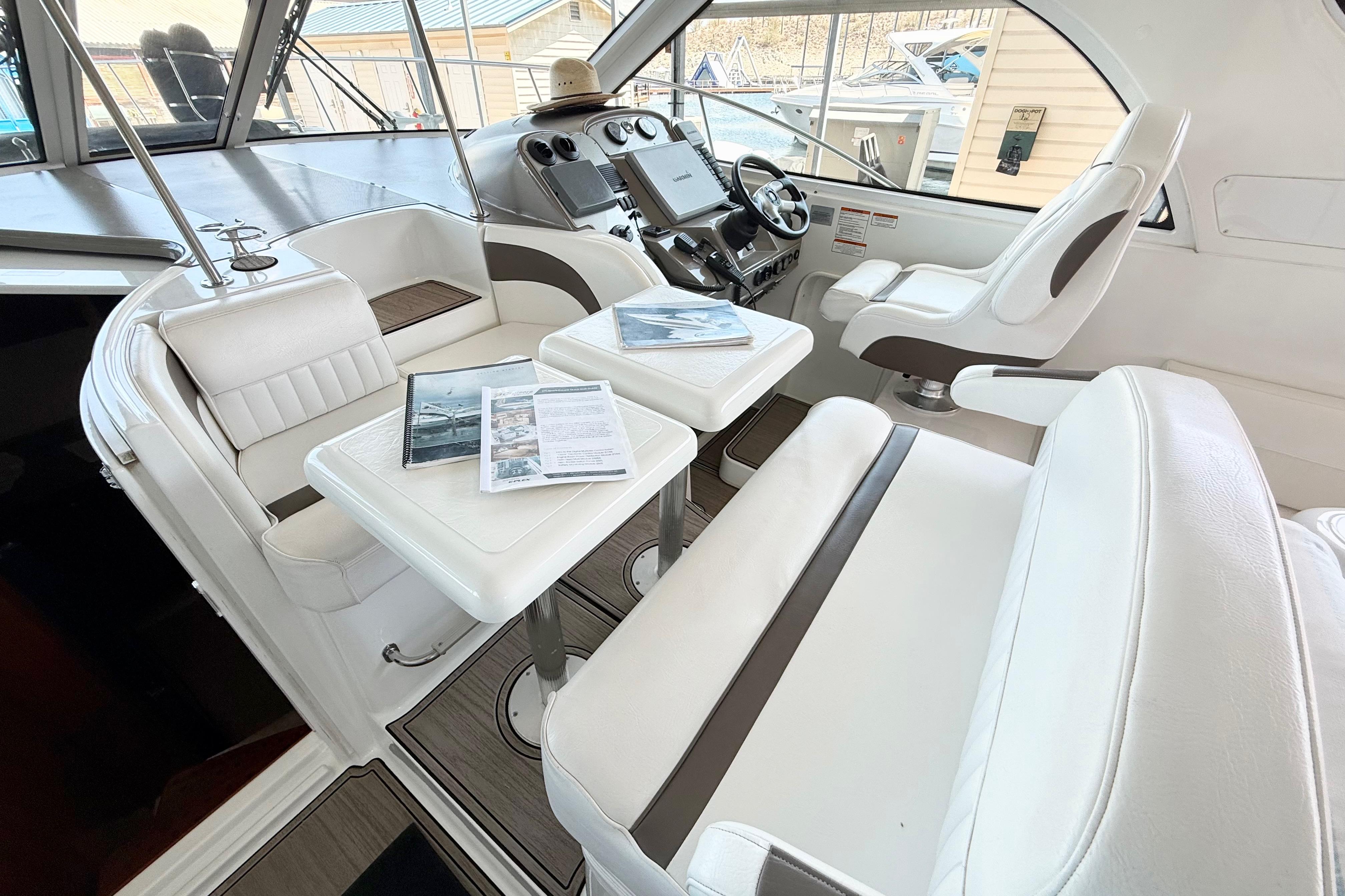 Interior of 2011 Cruisers Yachts 390 Sports Coupe with white seating and navigation controls.