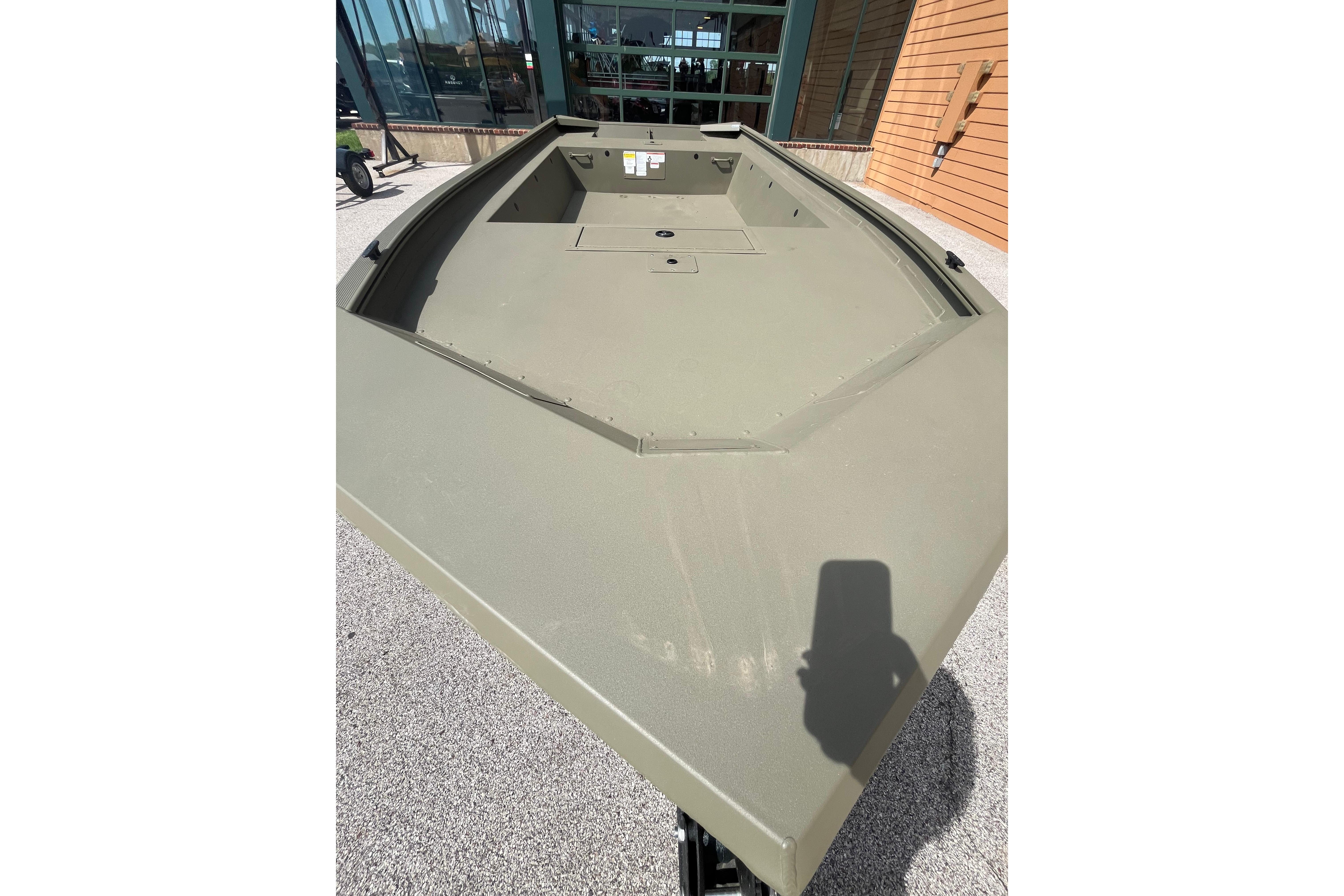2026 Tracker Grizzly 1754 Utility boat displayed outdoors, showcasing its spacious deck design.
