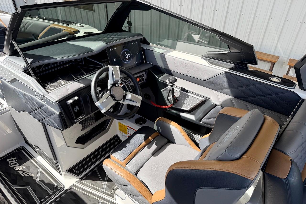 Interior of 2025 Tigé Ultré 25ZX boat with modern dashboard and steering wheel.