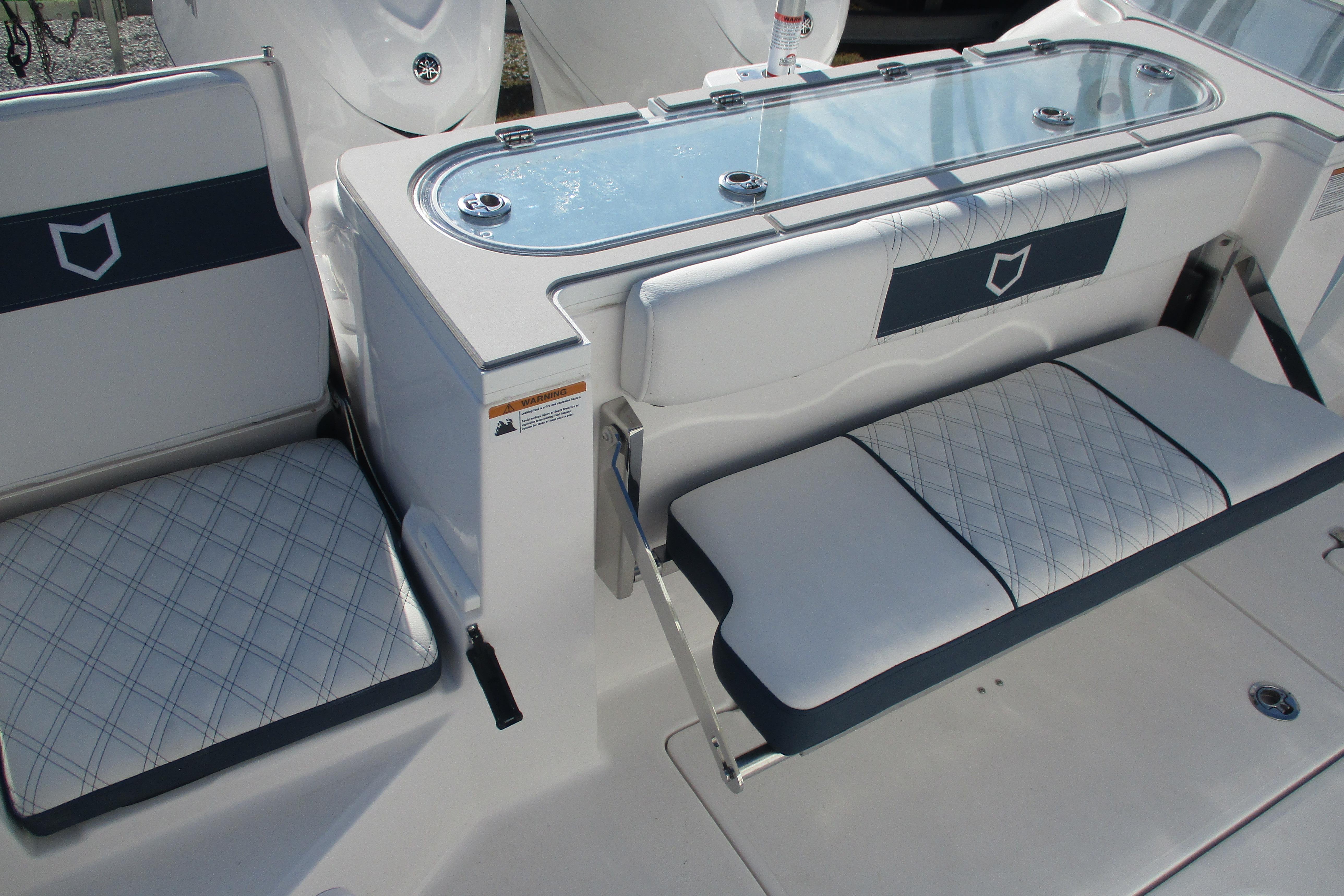 2026 Sea Fox 328 Commander boat seating and storage area with elegant design.