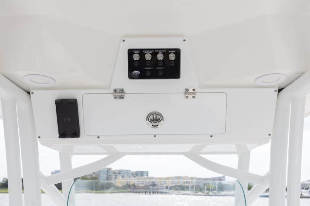 Control panel of 2027 Sea Fox 248 Commander boat with switches and storage compartment.