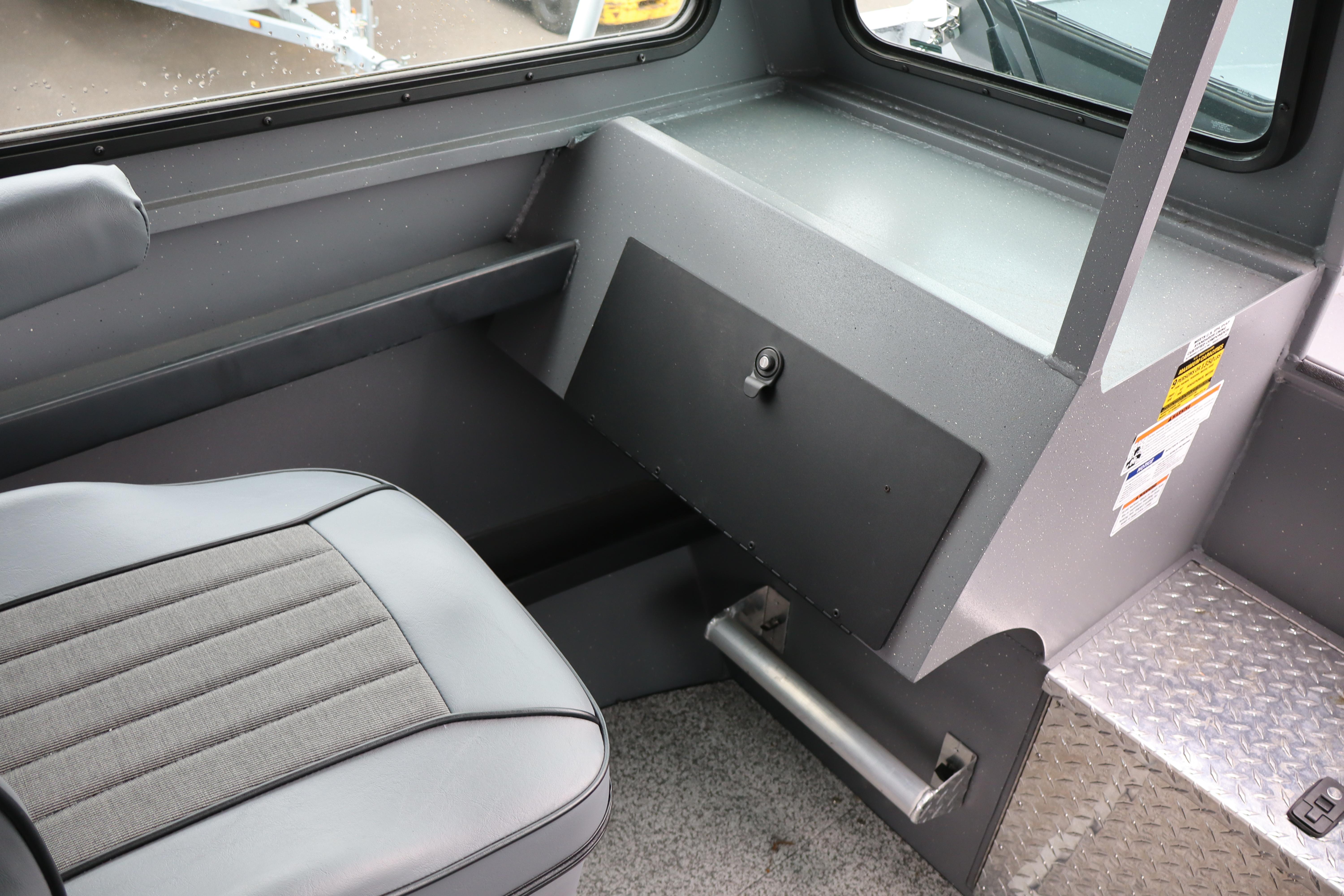Interior of 2026 Alumaweld Horizon 24 boat with seating and storage compartment.