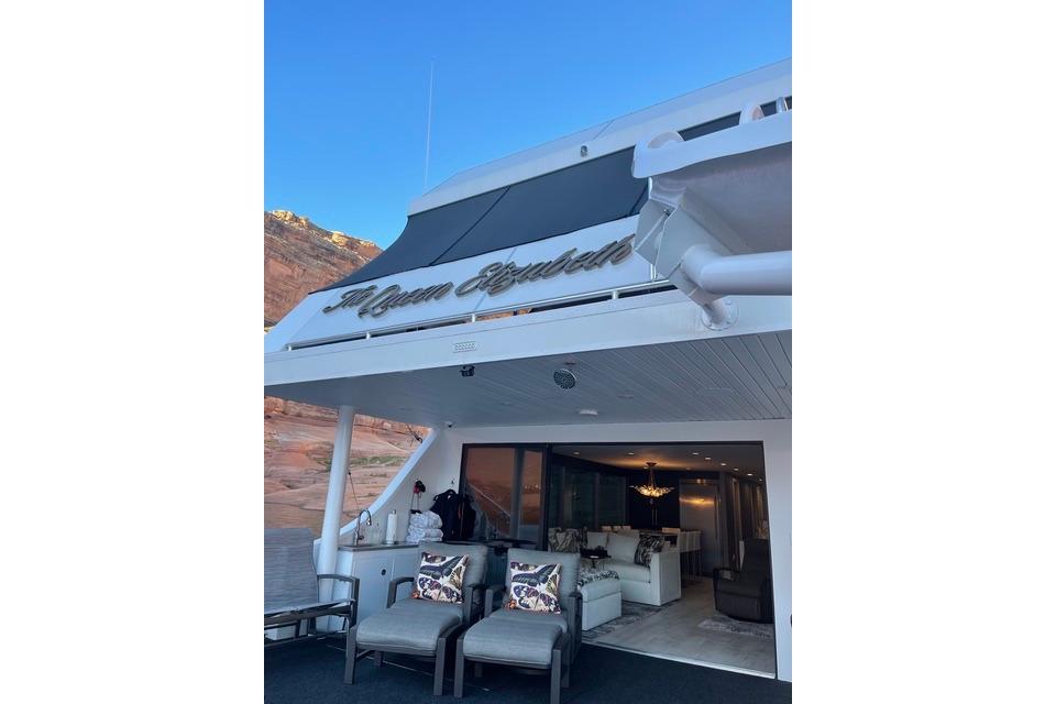 Luxury yacht "The Queen Elizabeth" by Adonia, 2021 model, with elegant outdoor seating.
