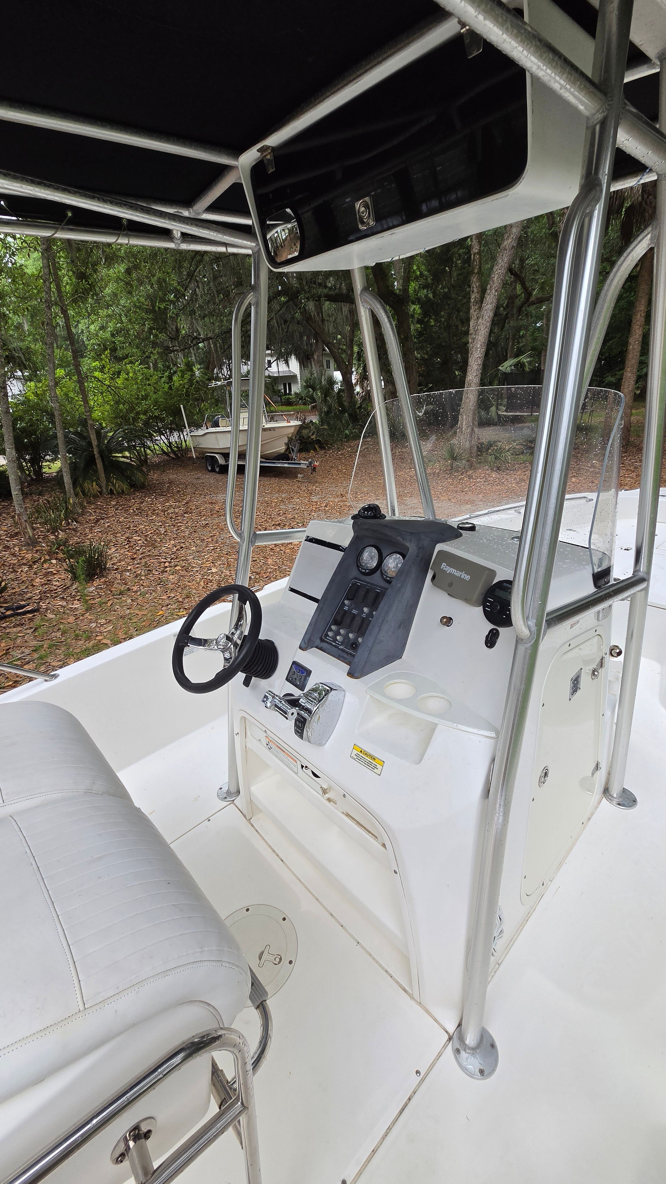 The image shows the cockpit of a 2008 Boston Whaler 230 Dauntless with a helm console and seating.