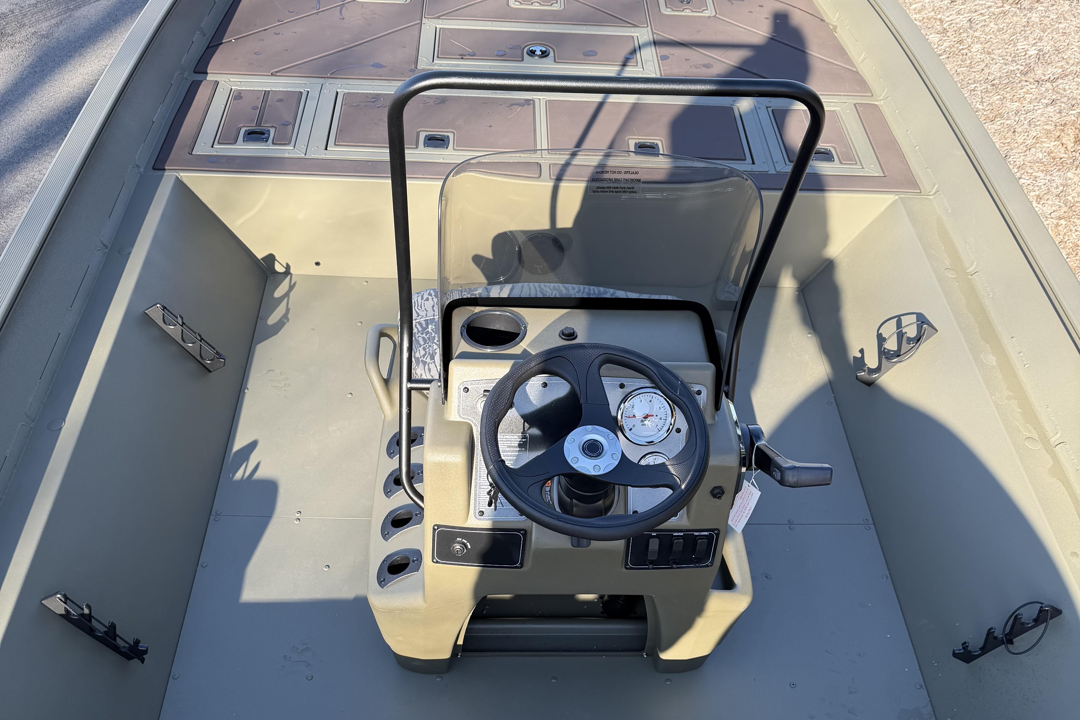 2026 Tracker Grizzly 2072 CC boat console with steering wheel and gauges.