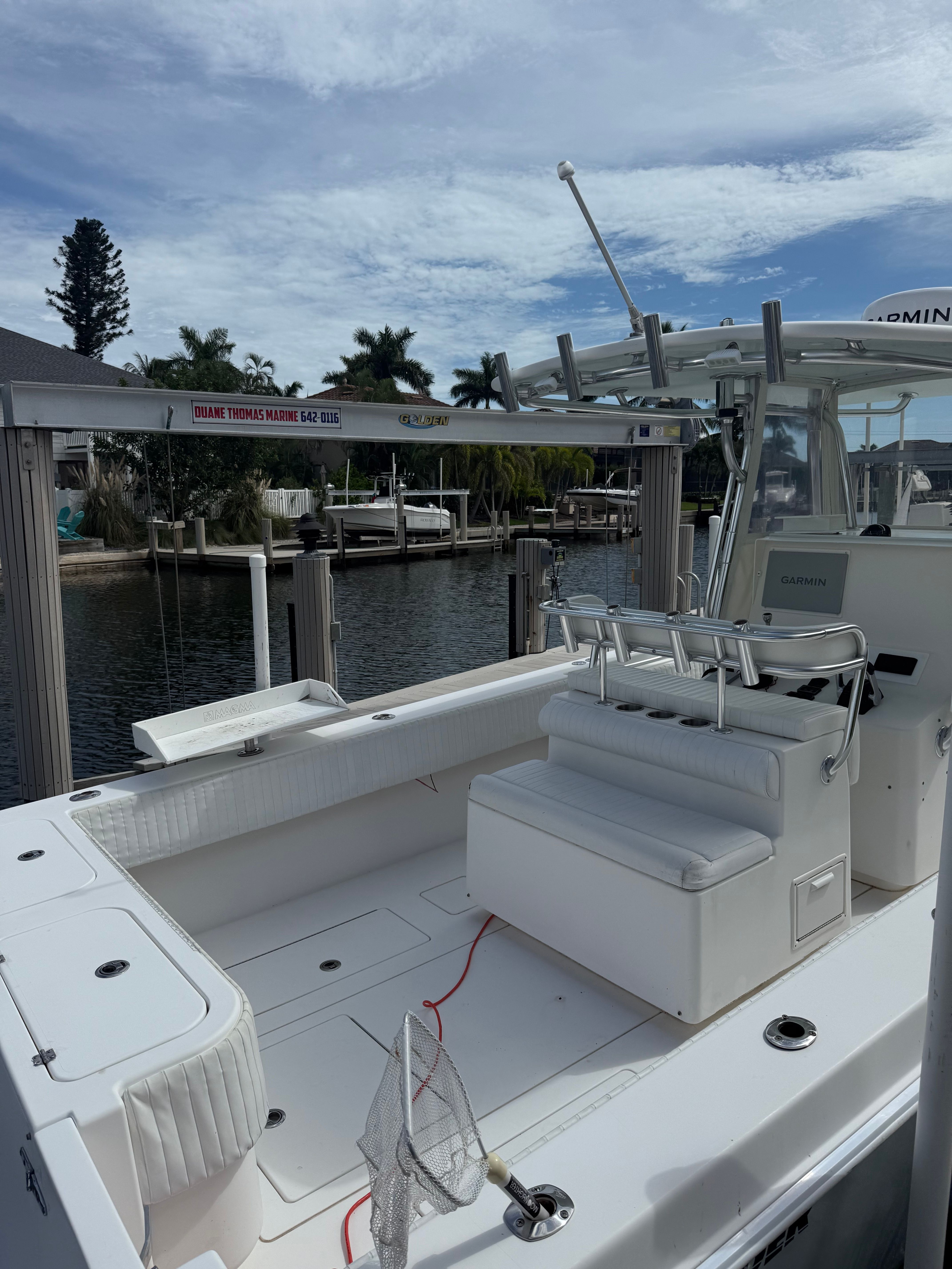 2012 Contender 32 ST boat docked under clear sky.