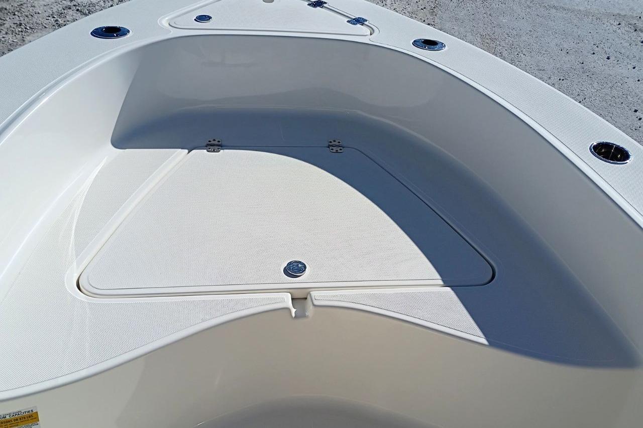 2026 Pioneer 180 Sportfish boat deck with storage compartment and cup holders.