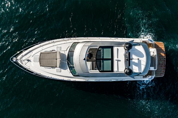 2021 Riviera 5400 Sport Yacht cruising on open water, aerial view.