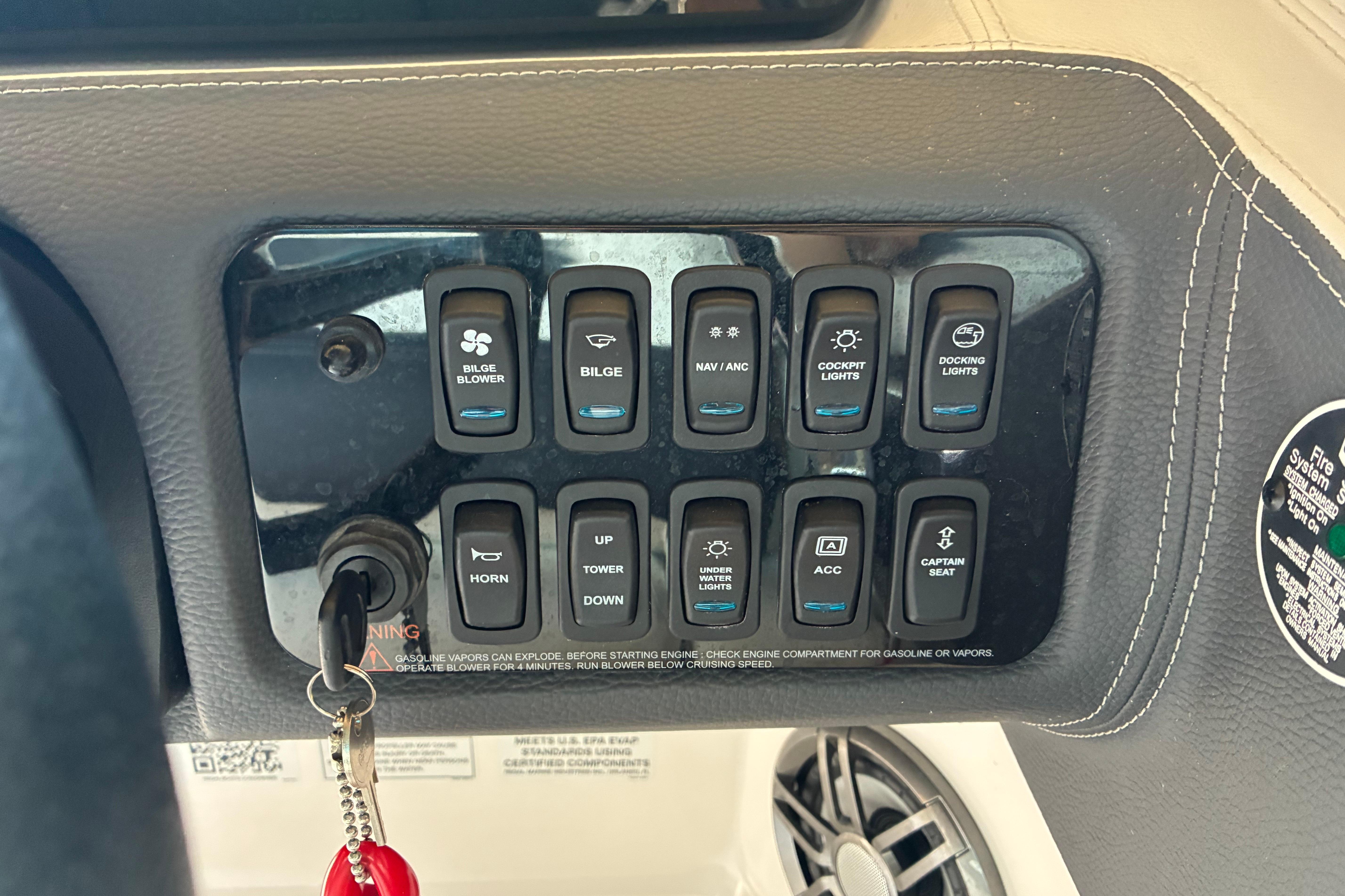 Control panel of a 2025 Regal LS2 boat with various switches and key ignition.