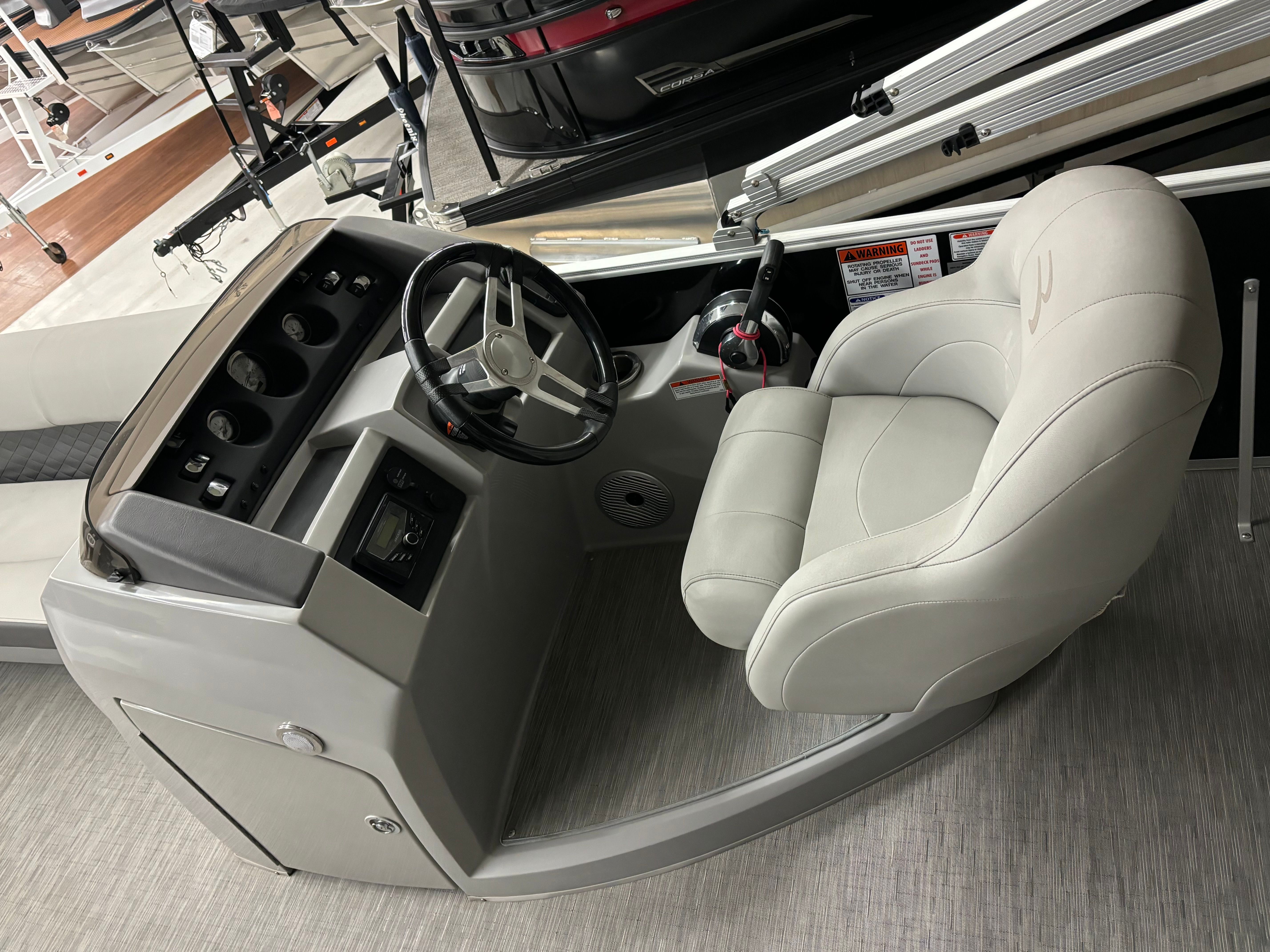 The image shows the helm of a 2022 Bennington L 23 Swingback with a comfortable seat.