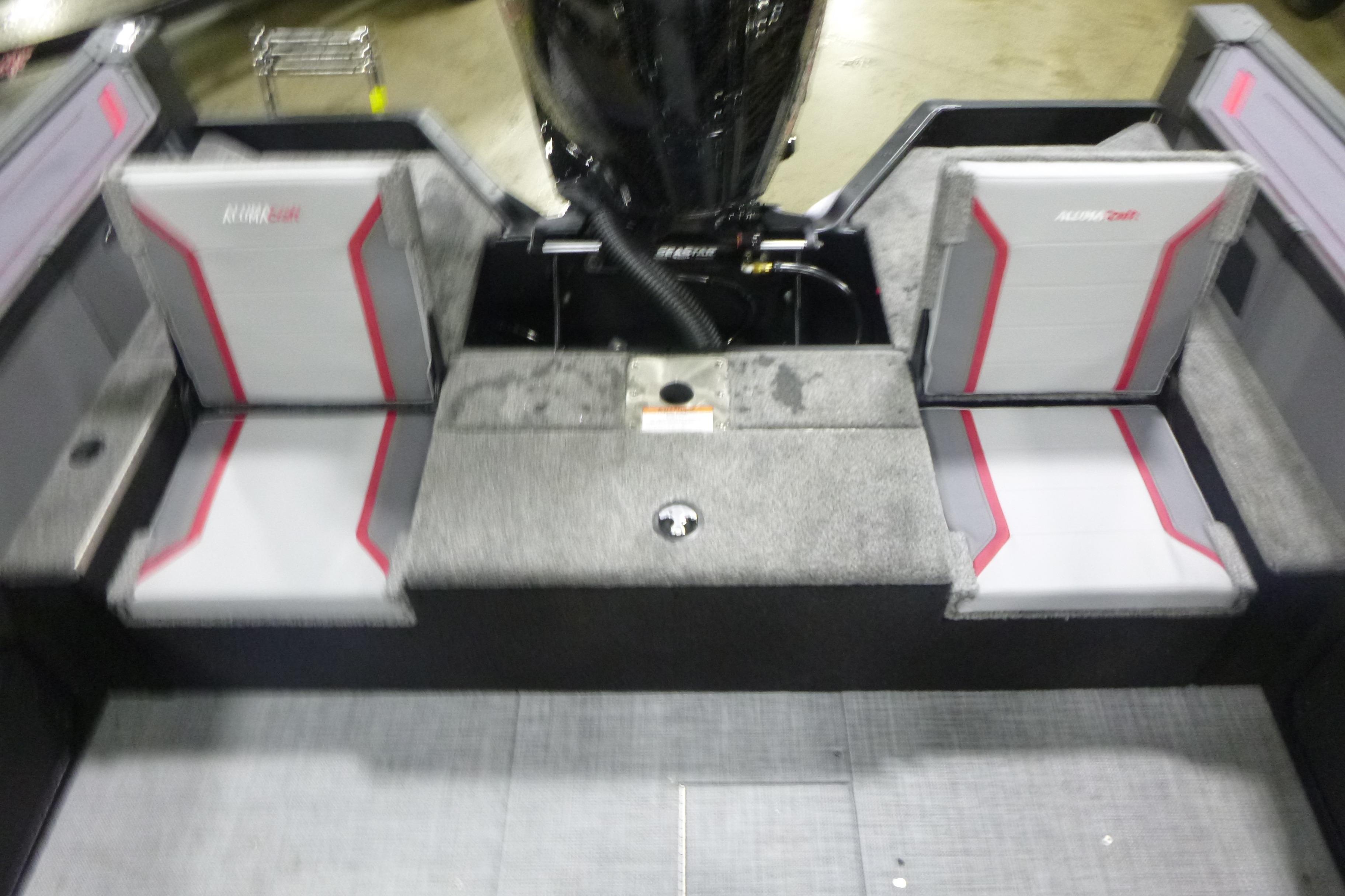 2026 Alumacraft Trophy 205X Sport boat interior with gray and red seating.