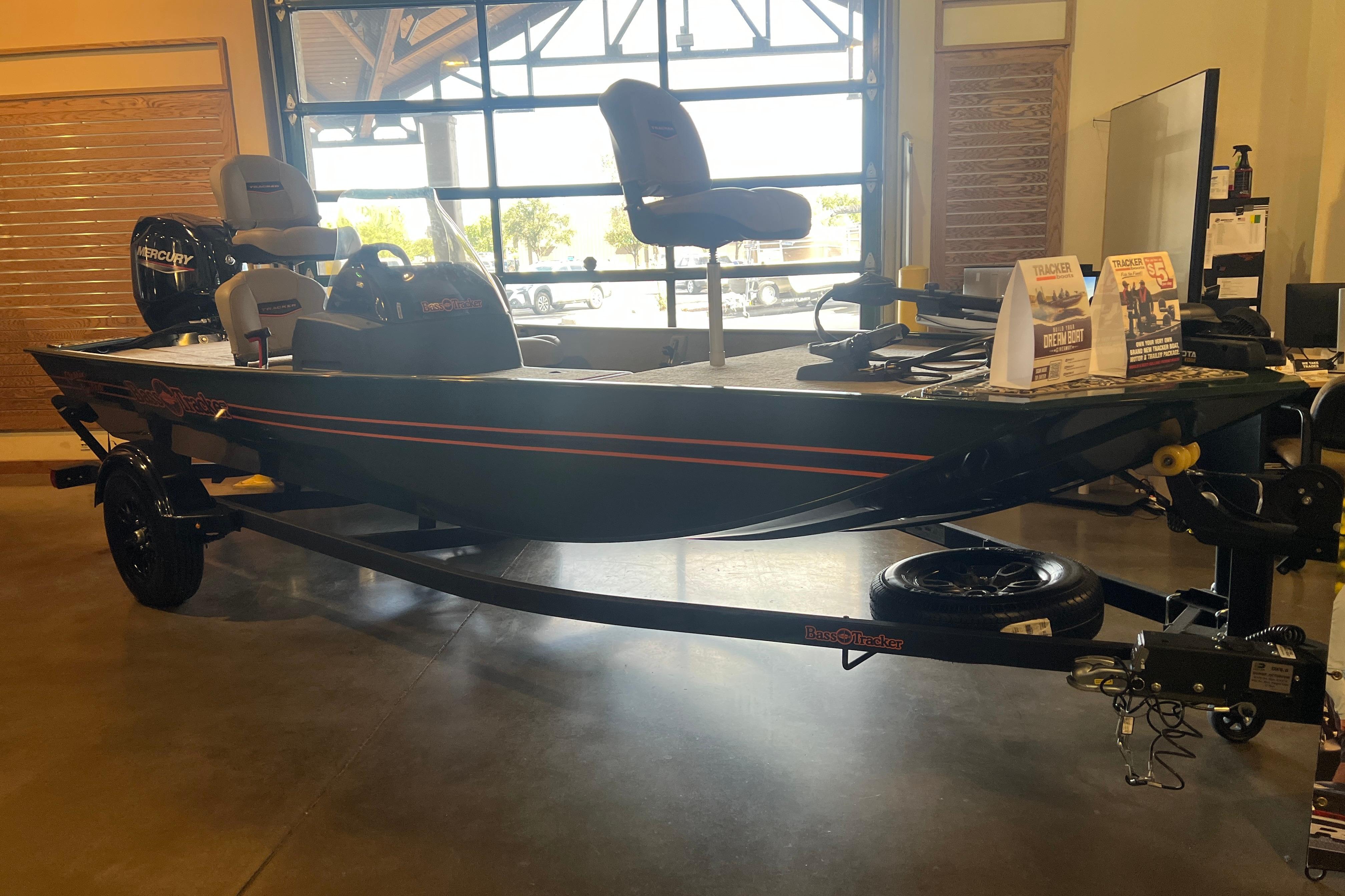 2026 Tracker Bass Tracker Classic Limited boat displayed indoors on a trailer.