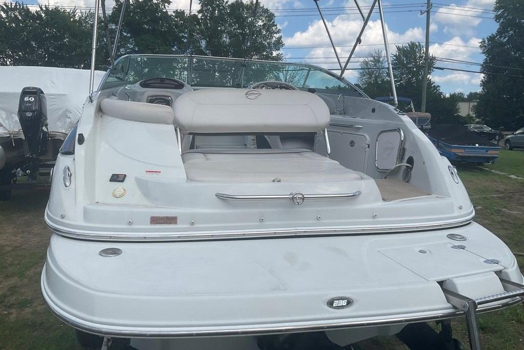 2015 Crownline 236 SC boat, rear view, white exterior, parked outdoors.