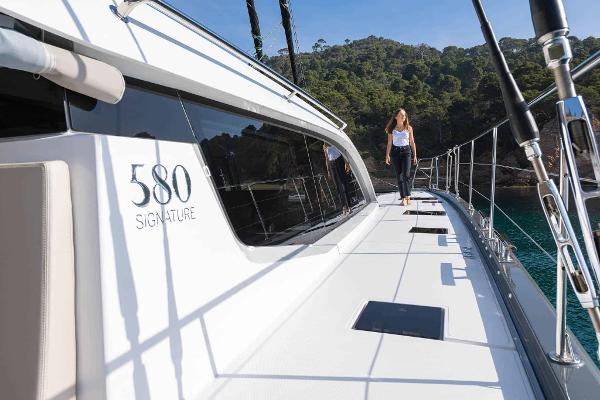 Luxury Privilege Signature 580 yacht, 2025 model, with person walking on deck.