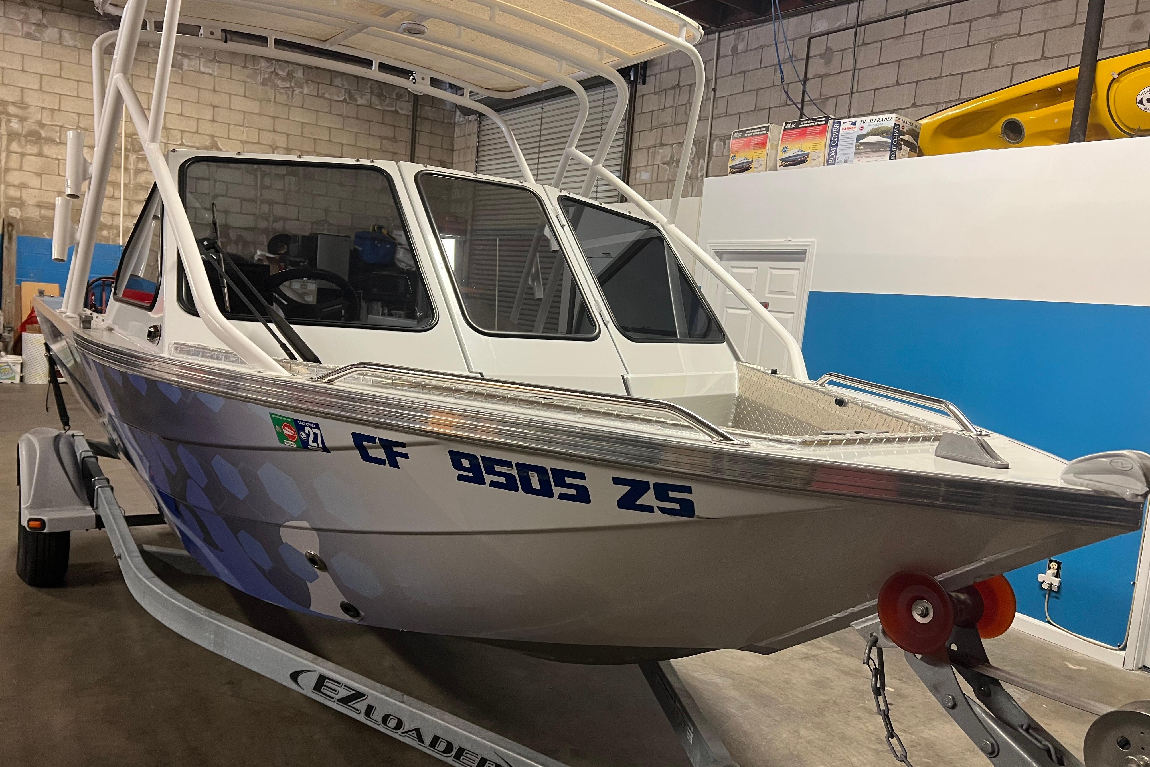 2019 KingFisher 1825 Falcon boat on trailer in garage setting.