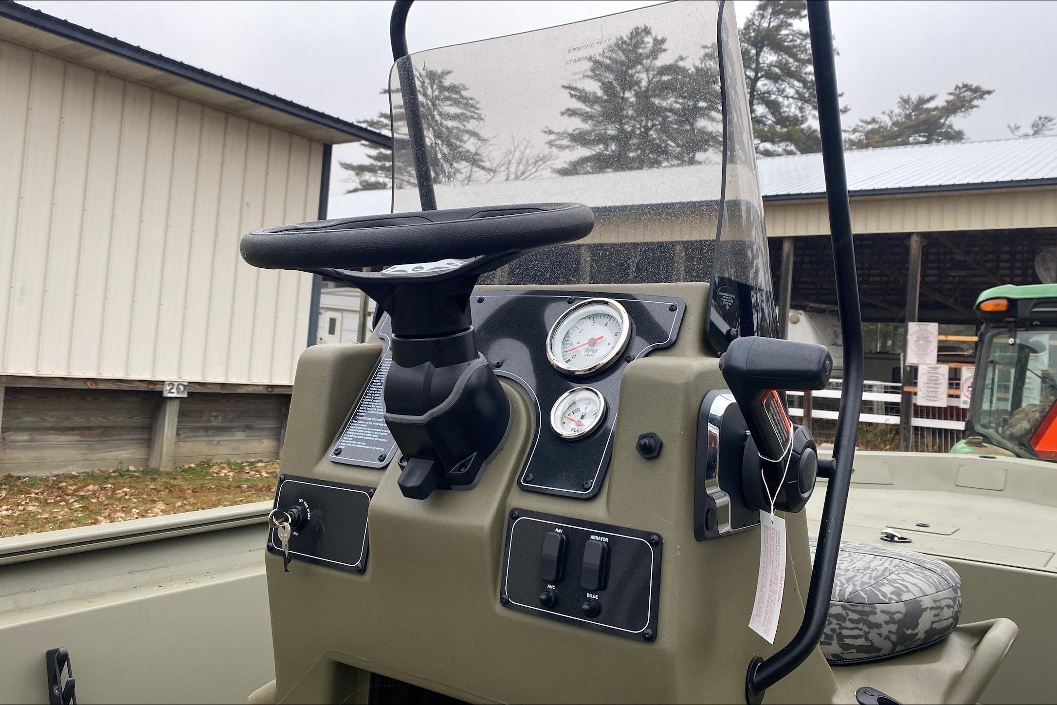 2026 Tracker Grizzly 1860 CC boat console with steering wheel and gauges.