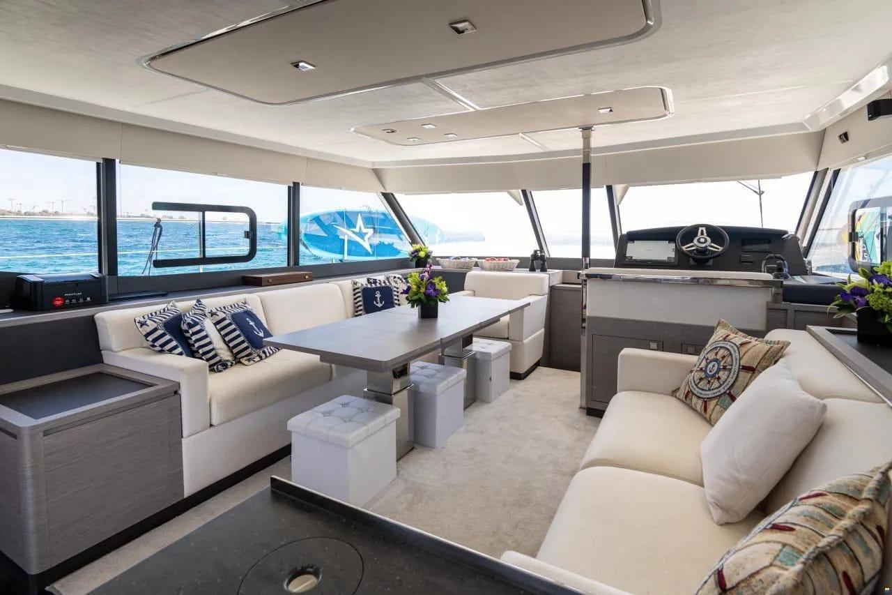 Luxurious interior of 2022 Fountaine Pajot MY6 yacht with elegant seating and nautical decor.