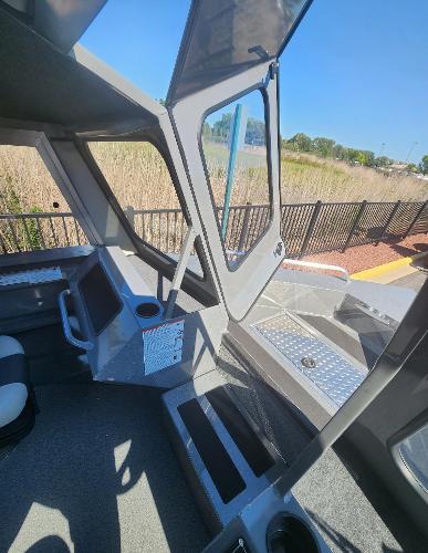 Interior view of 2025 Spartan 200 Astoria boat with open cabin and seating.