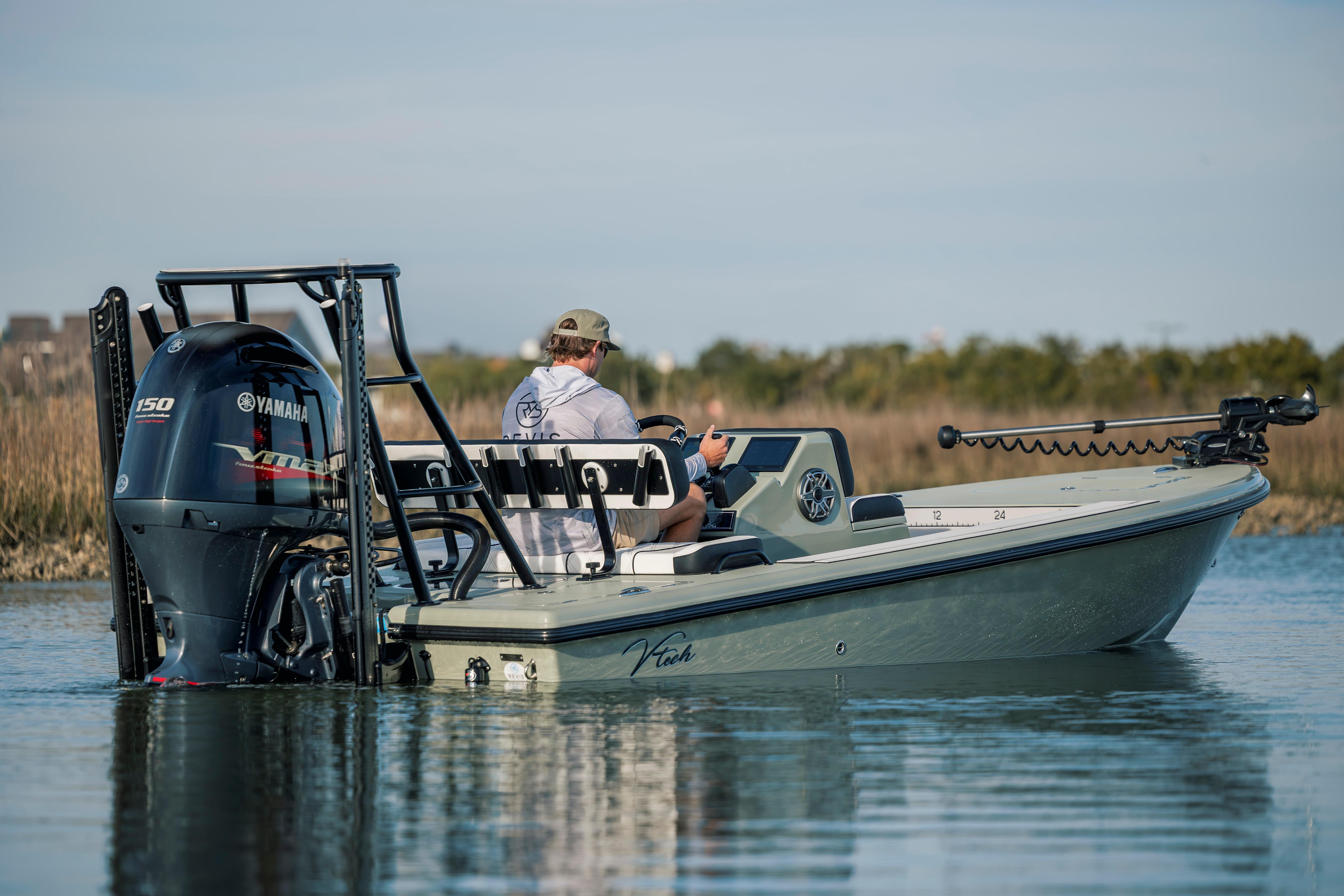 Man operating Vtech 18 boat with Yamaha engine on calm water, 2025 model.