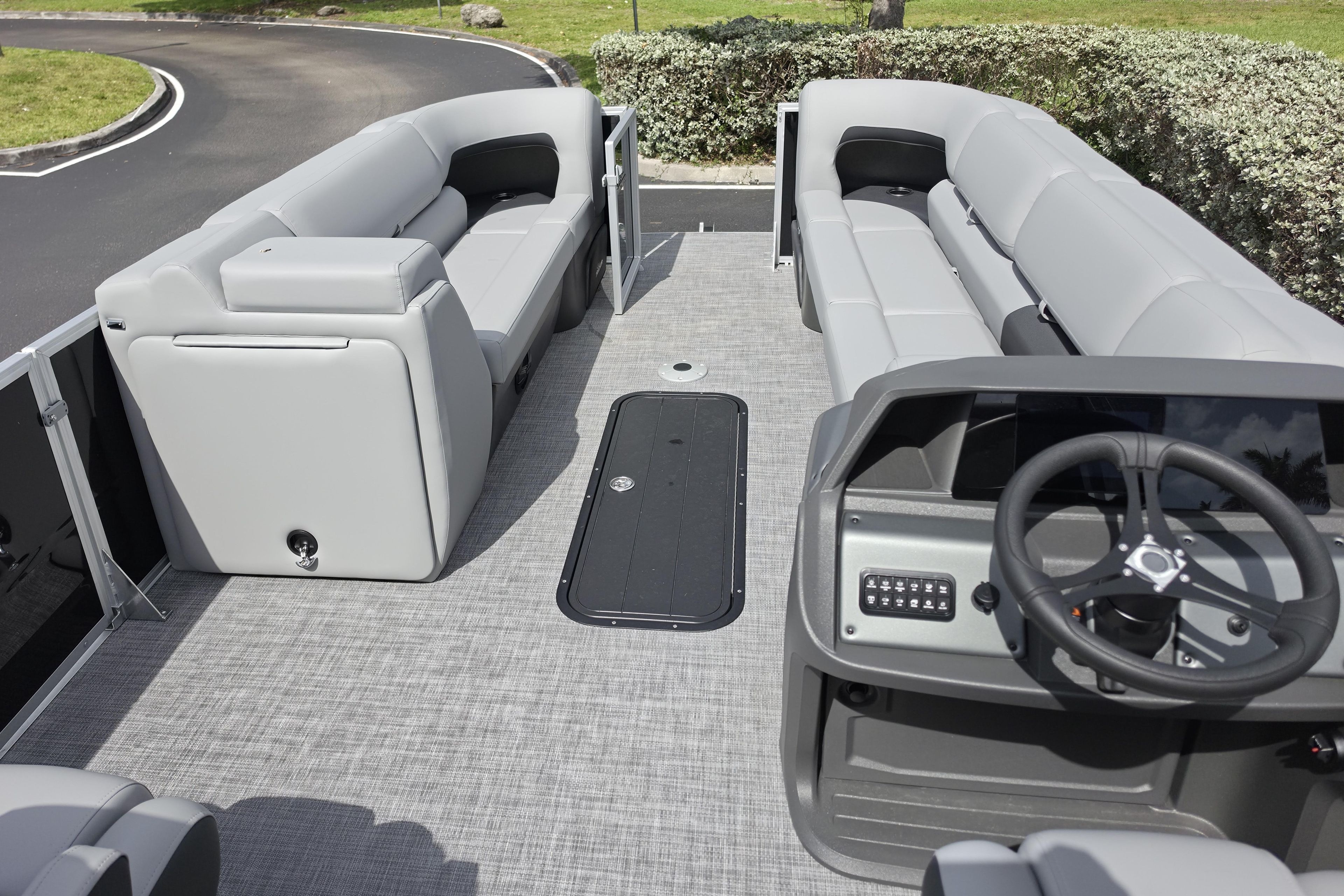 2026 Sun Tracker Party Barge 24 XP3 interior with gray seating and steering console.