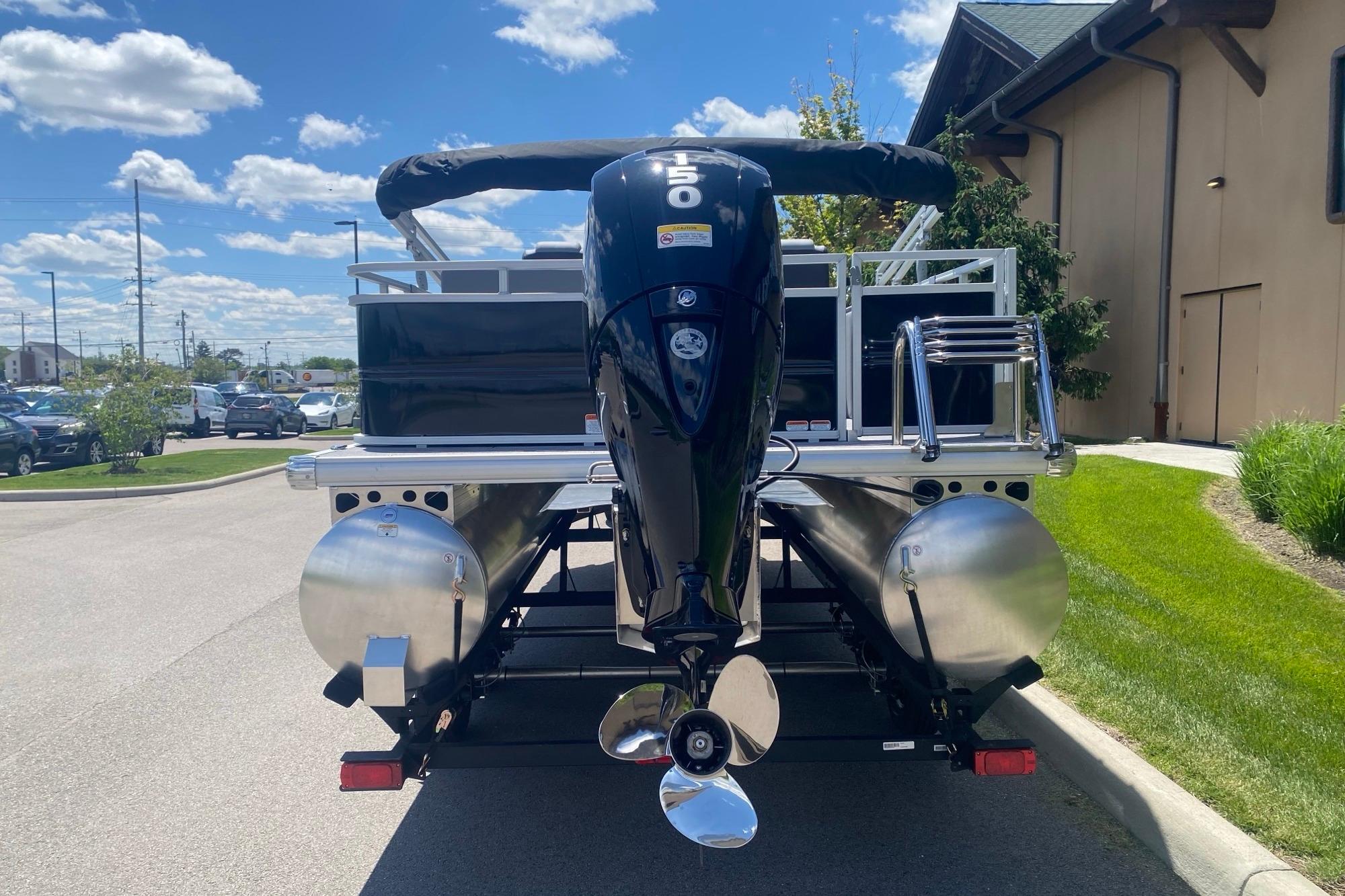 2026 Sun Tracker Party Barge 22 RF DLX pontoon boat with powerful outboard motor.