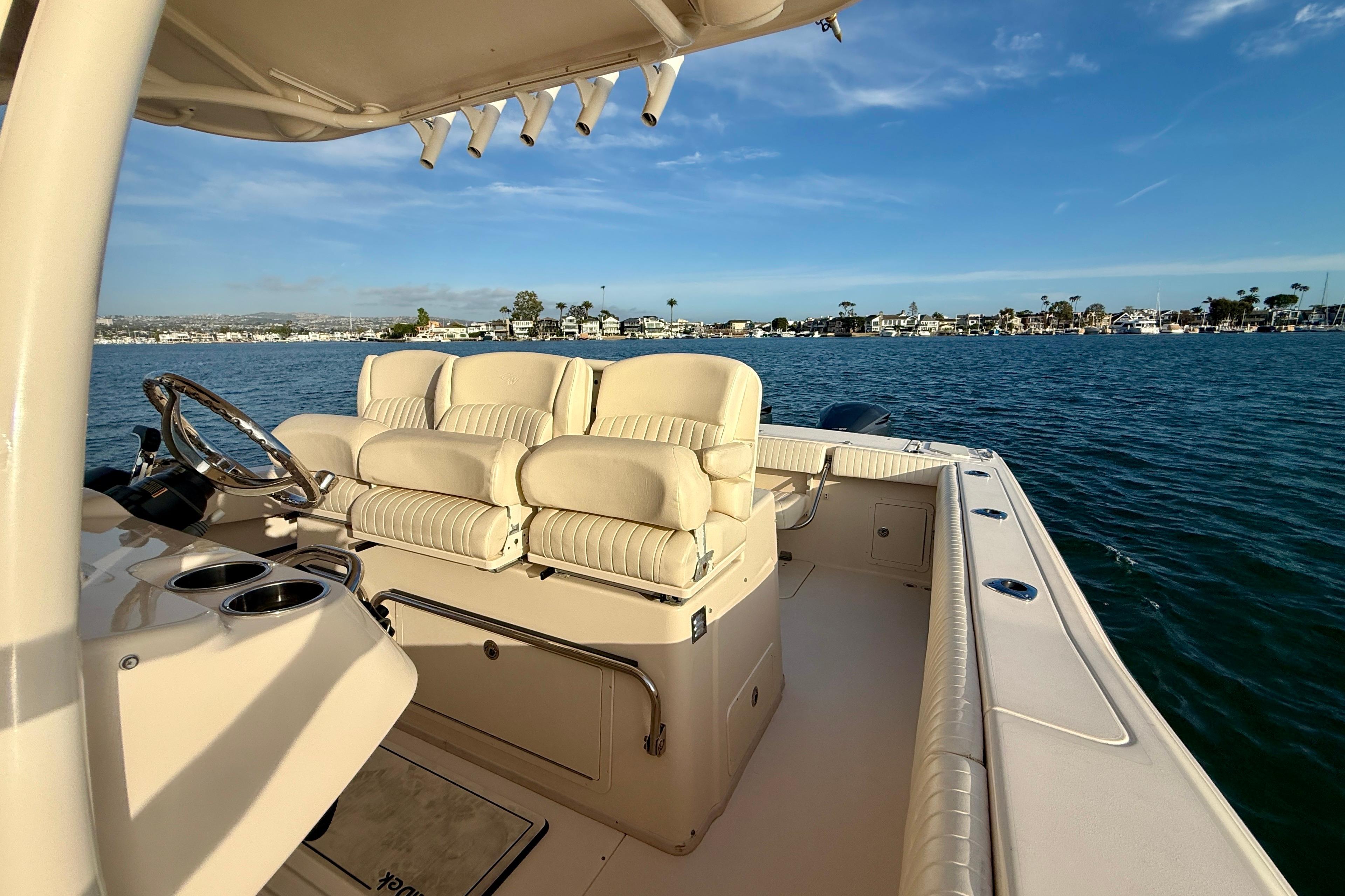 2012 Grady-White Canyon 336 boat interior with plush seating on calm water.