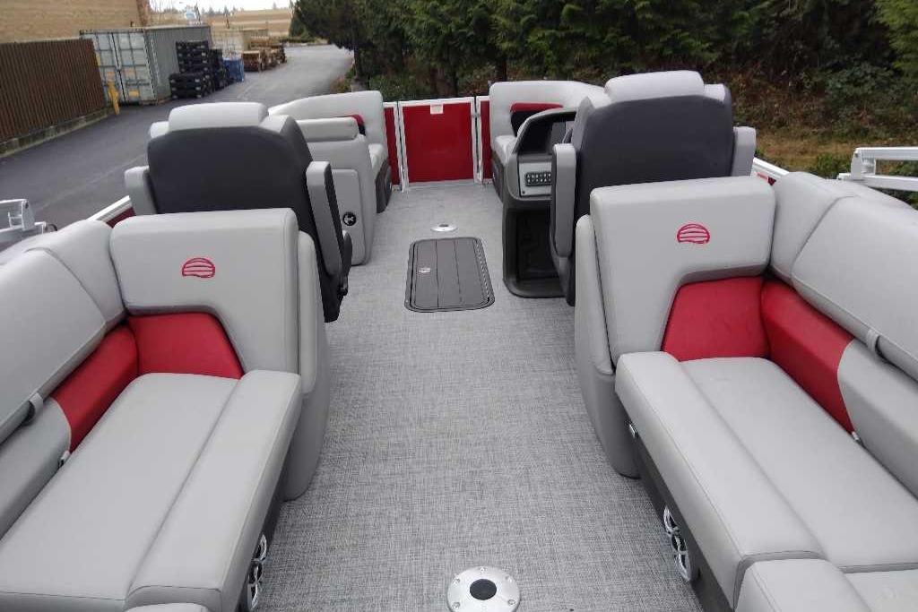 2026 Sun Tracker Party Barge 22 XP3 interior with gray and red seating, spacious layout.