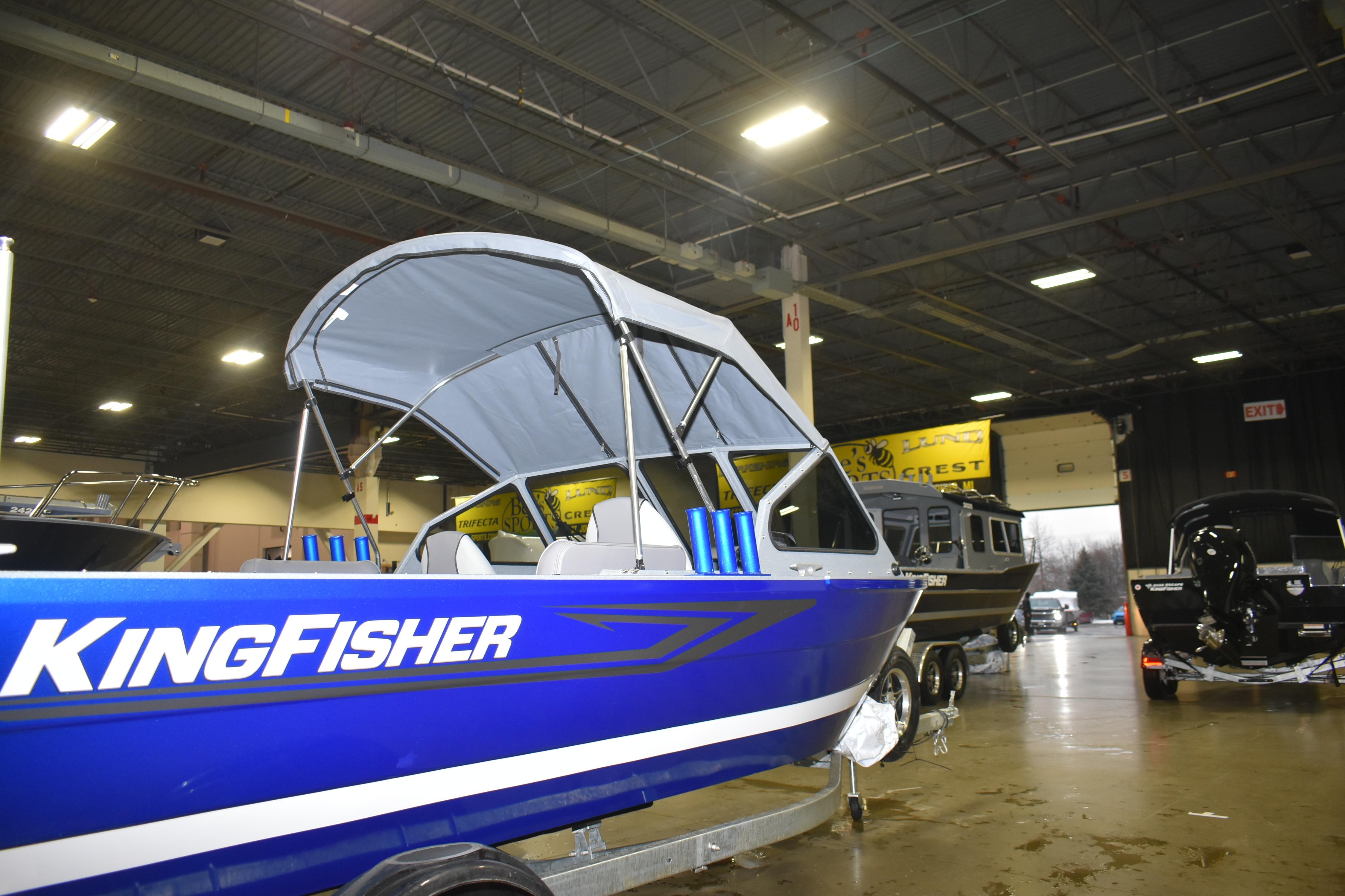 2026 KingFisher 1825 Falcon boat displayed indoors, featuring a sleek blue design.