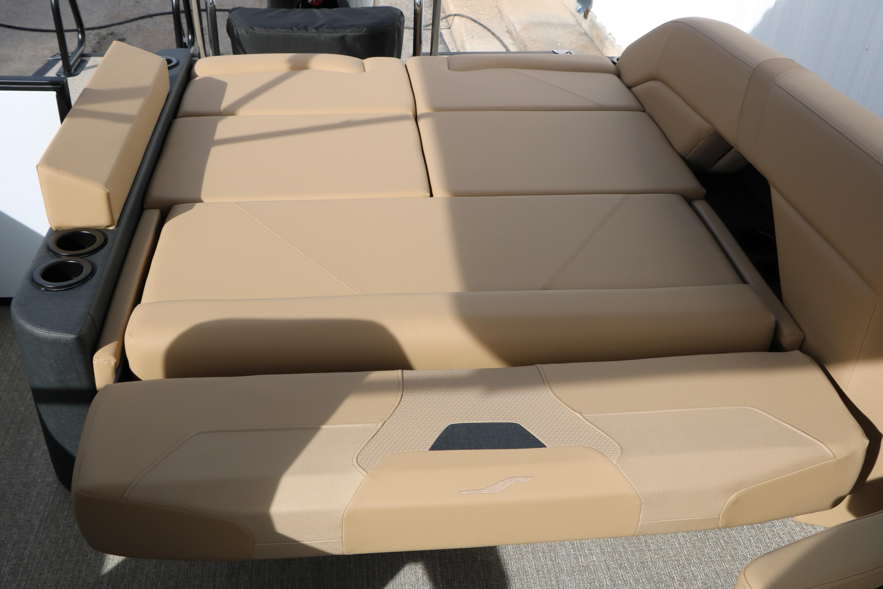 Luxurious beige seating on 2026 Evotti 523CS boat, featuring cup holders and modern design.