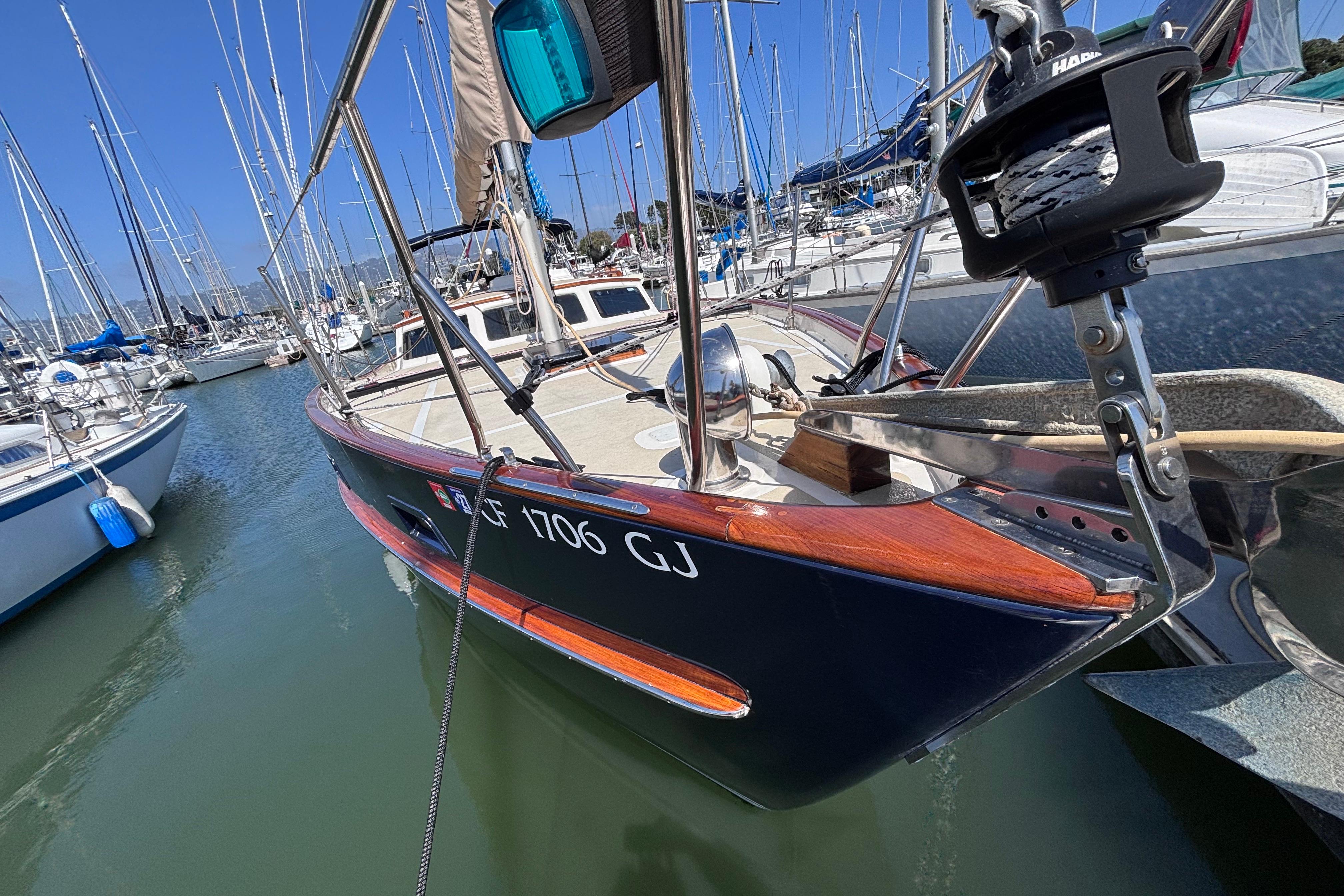 1978 Swift 33 sailboat docked in marina, featuring wooden accents and sleek design.