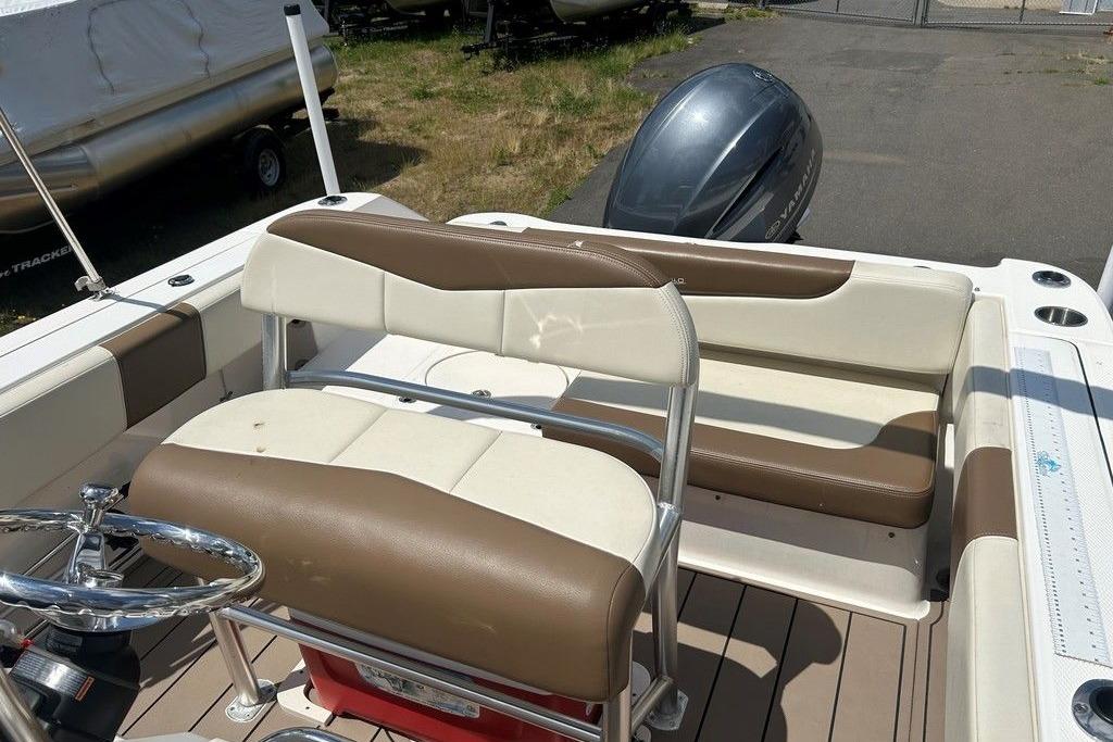 2017 Robalo R200ES boat interior with brown and white seating, steering wheel, and outboard motor.