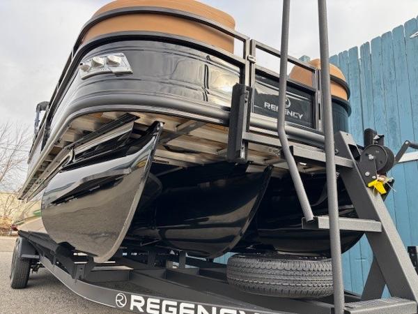 2025 Regency 230 LE3 pontoon boat on trailer, sleek black design.
