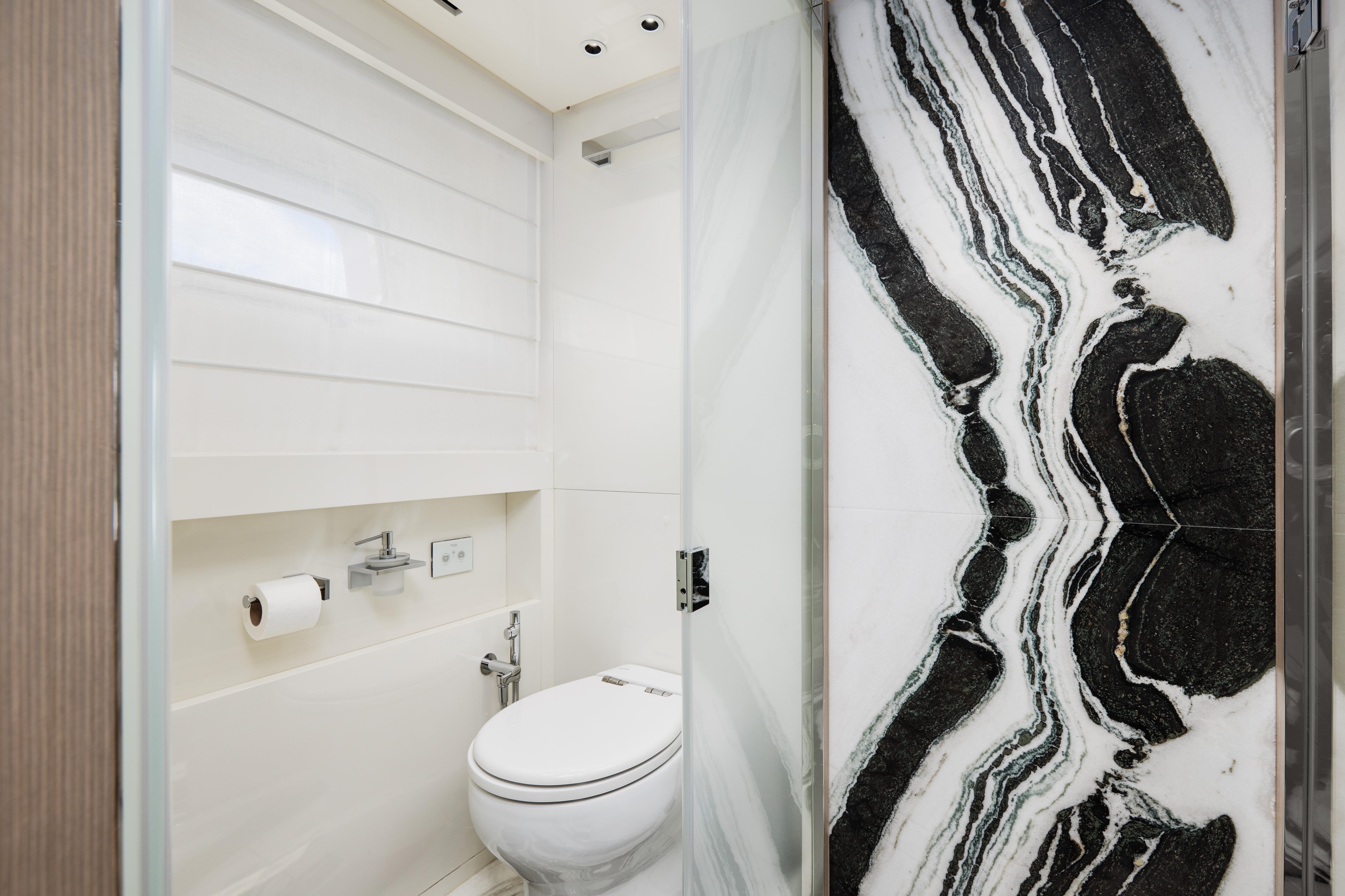 Luxurious bathroom in 2020 Sanlorenzo SX88 yacht with elegant marble wall design.