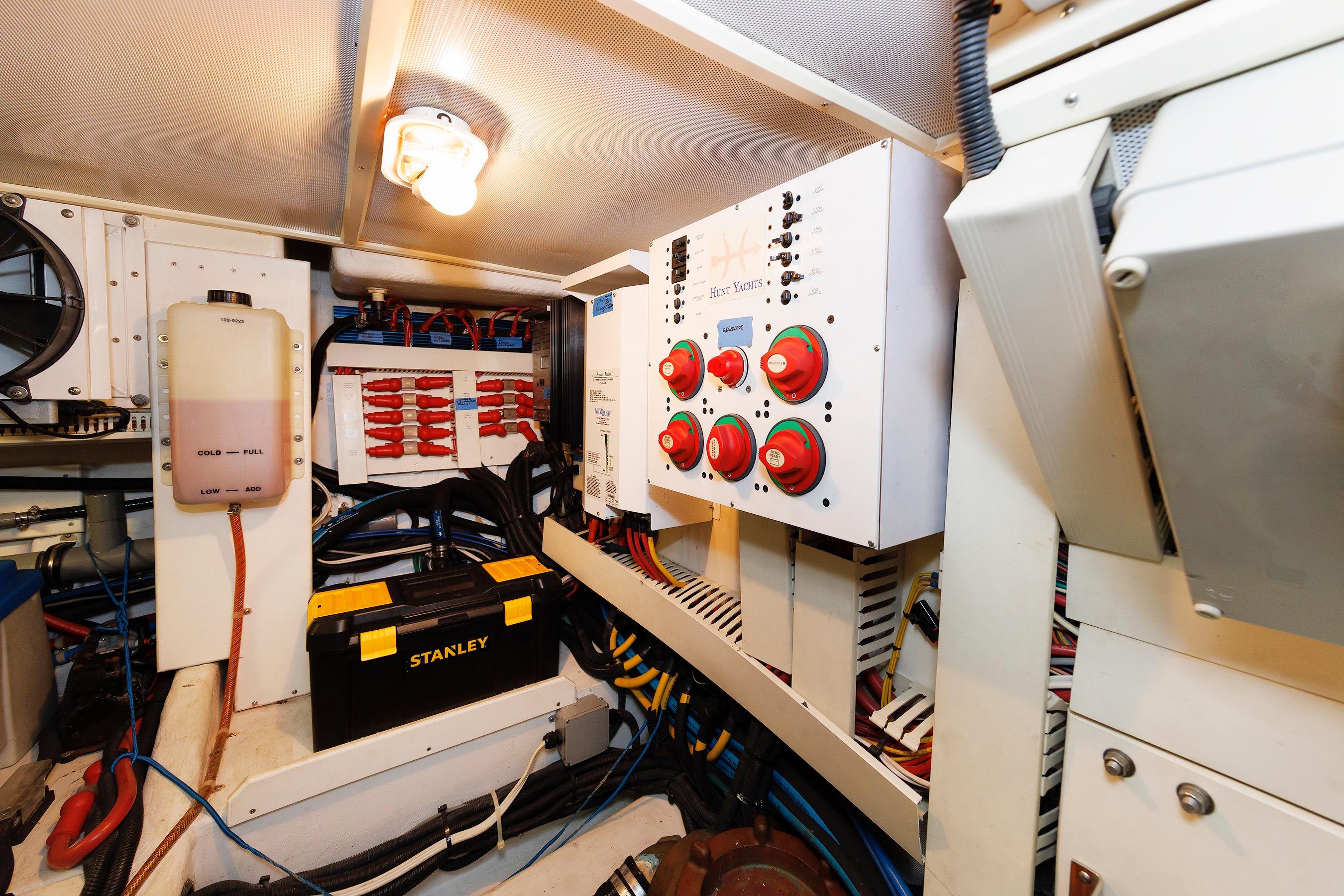 Engine room of 2009 Hunt Yachts 52 Express, featuring control panels and wiring.