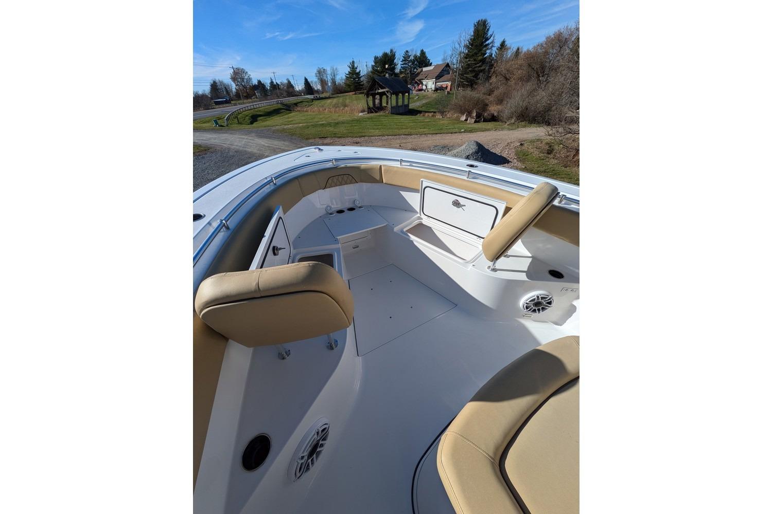 2025 Sportsman Open 282 Center Console boat interior with tan seating and storage compartments.