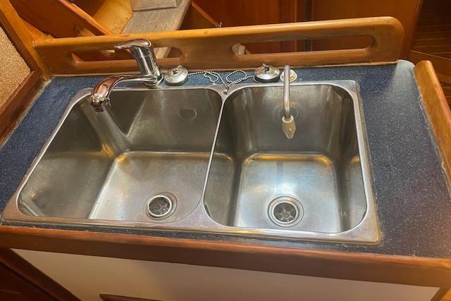 Double stainless steel sink in a 2001 Tartan 3700 yacht kitchen.
