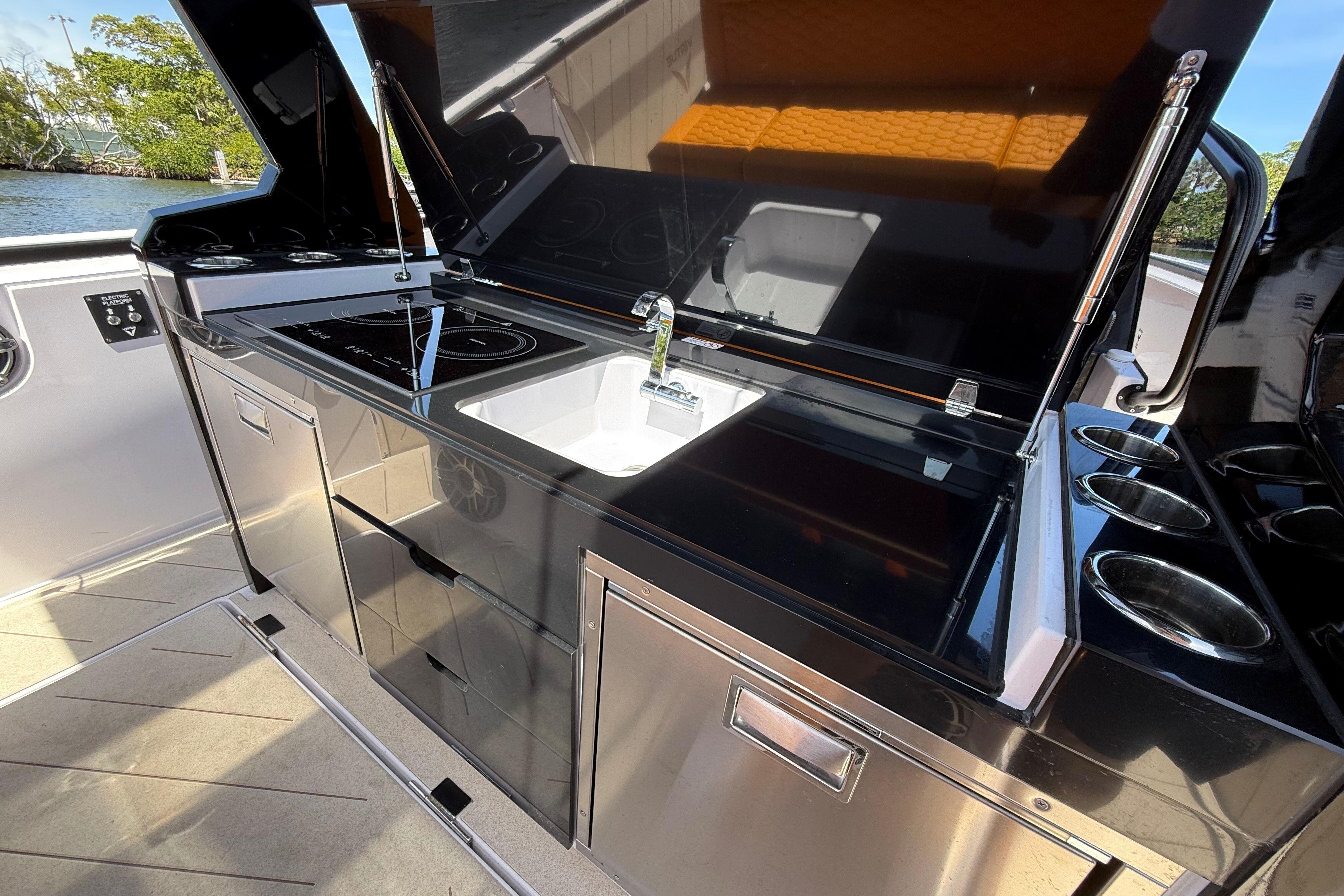 Modern kitchen area on 2026 VIRTUE YACHTS V10 TOP with sleek appliances and sink.