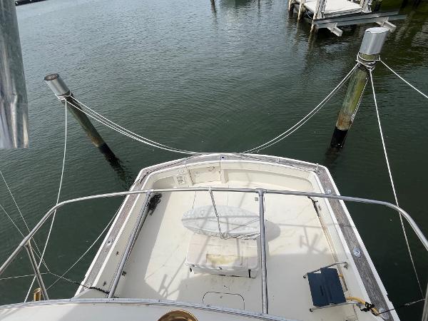 1985 Hatteras 45 Convertible boat docked at marina, view from above.