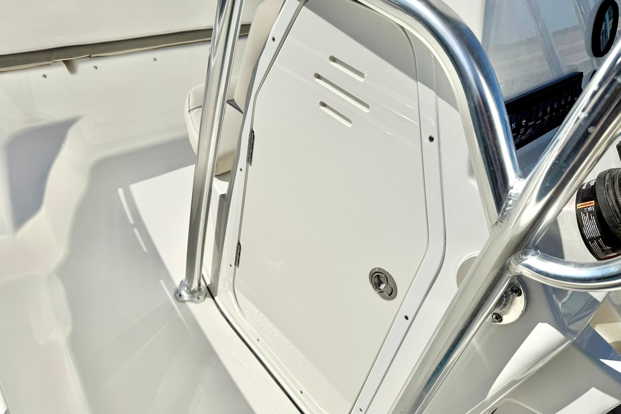 2026 Key West 189 FS boat console with stainless steel railings and storage compartment.