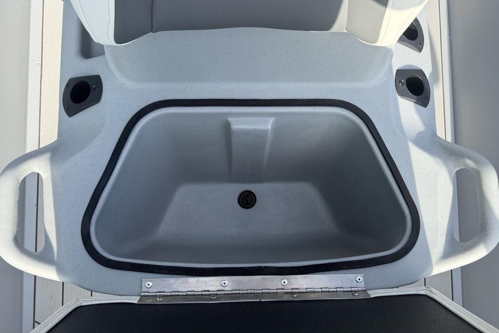 2026 Tracker Bass Tracker Classic CC boat storage compartment with cup holders.